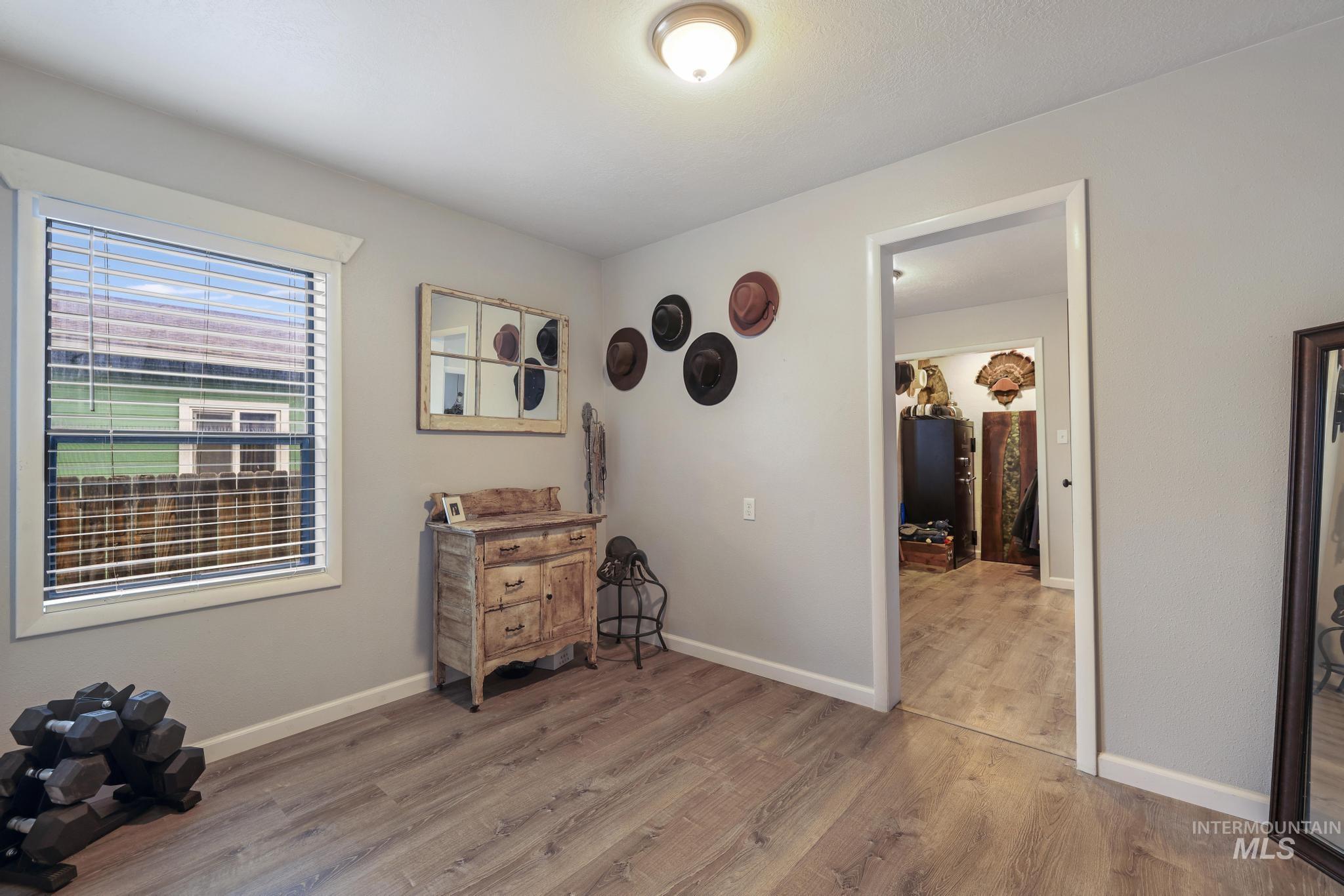 Bedroom with light wood-type flooring and baseboards