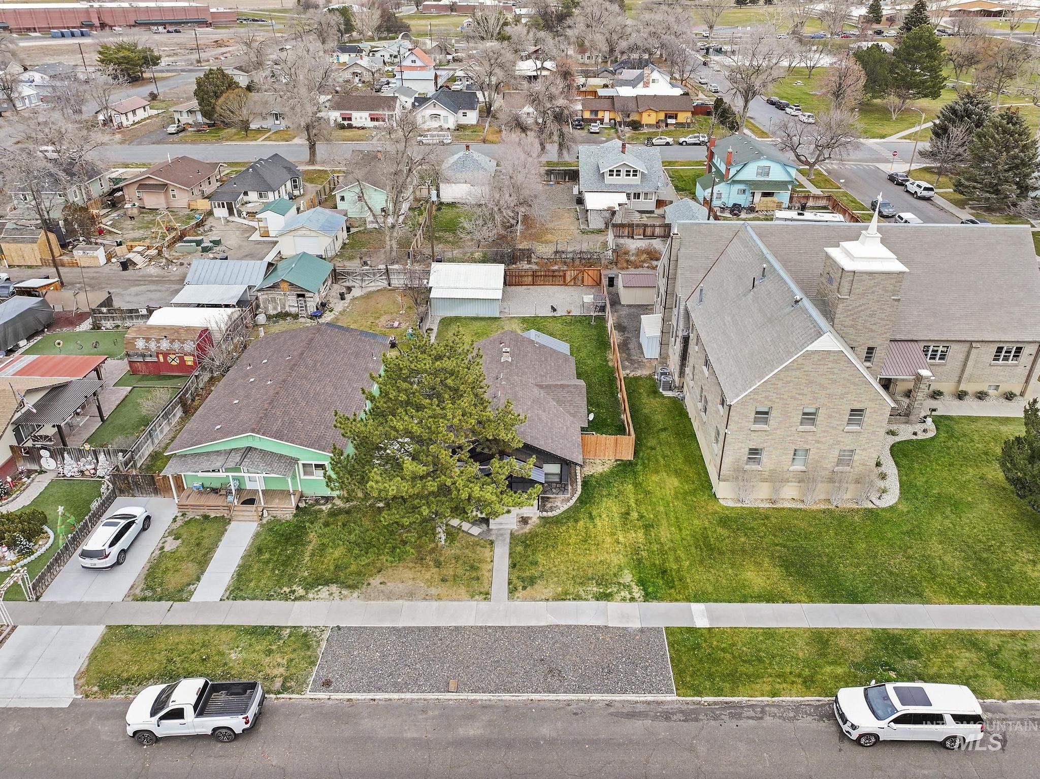 Aerial view of property and surrounding area with nearby suburban area