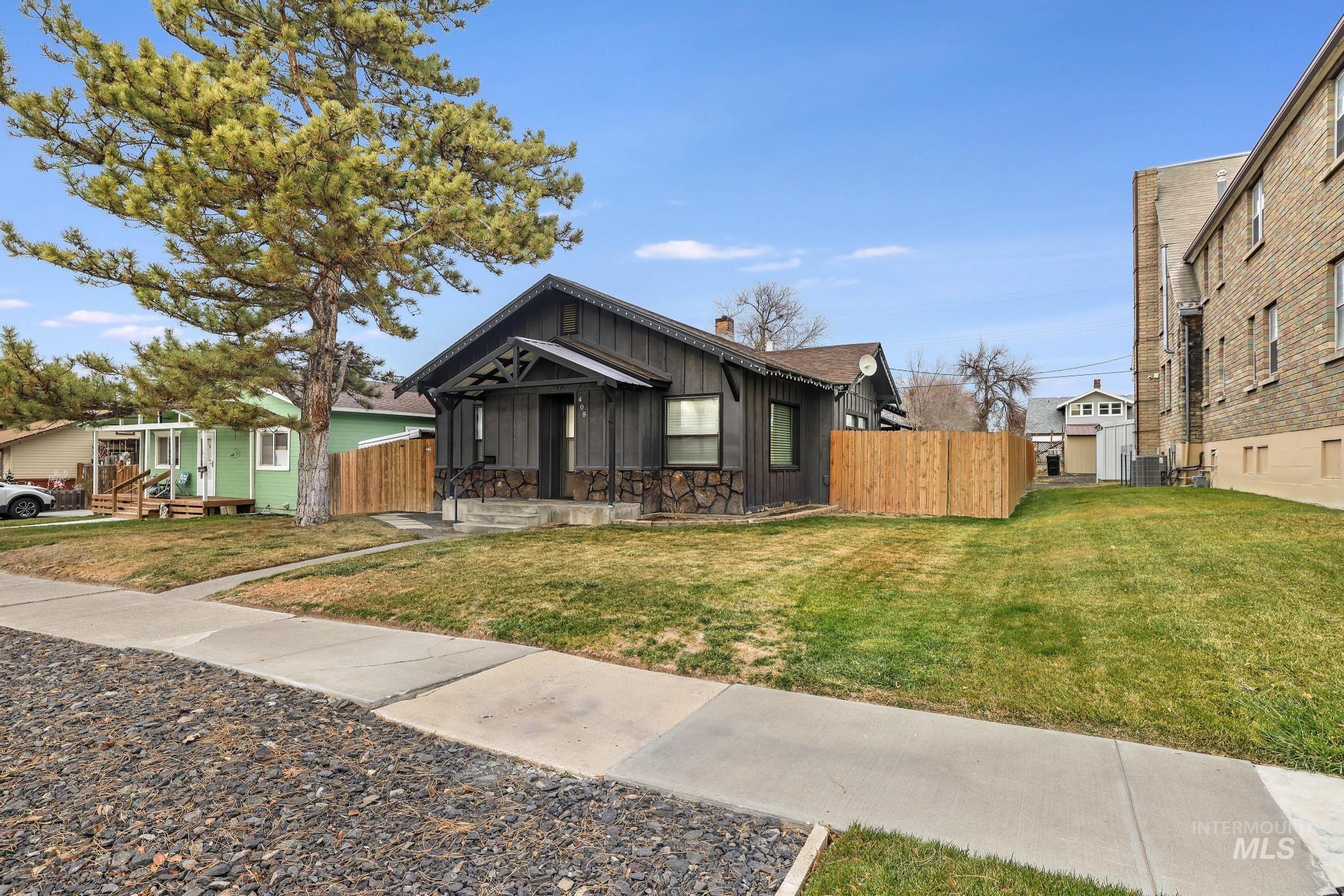 View of front facade featuring board and batten siding and stone siding
