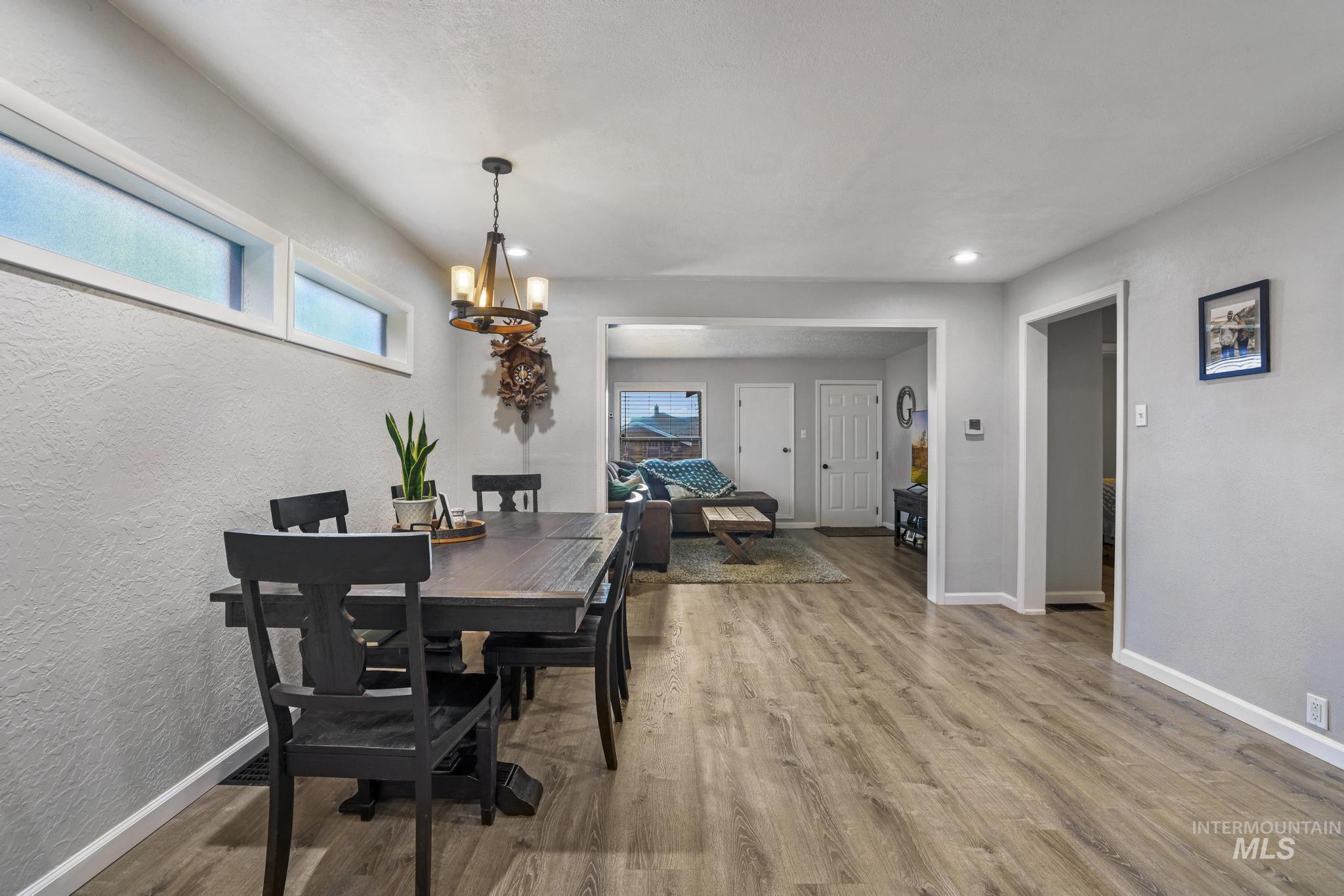 Dining area featuring wood finished floors and a chandelier