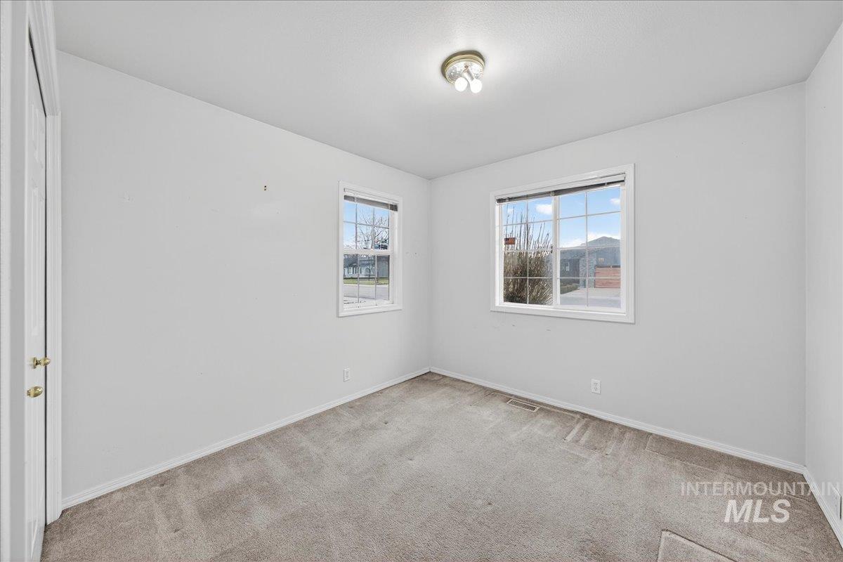 Spare room with carpet flooring and baseboards