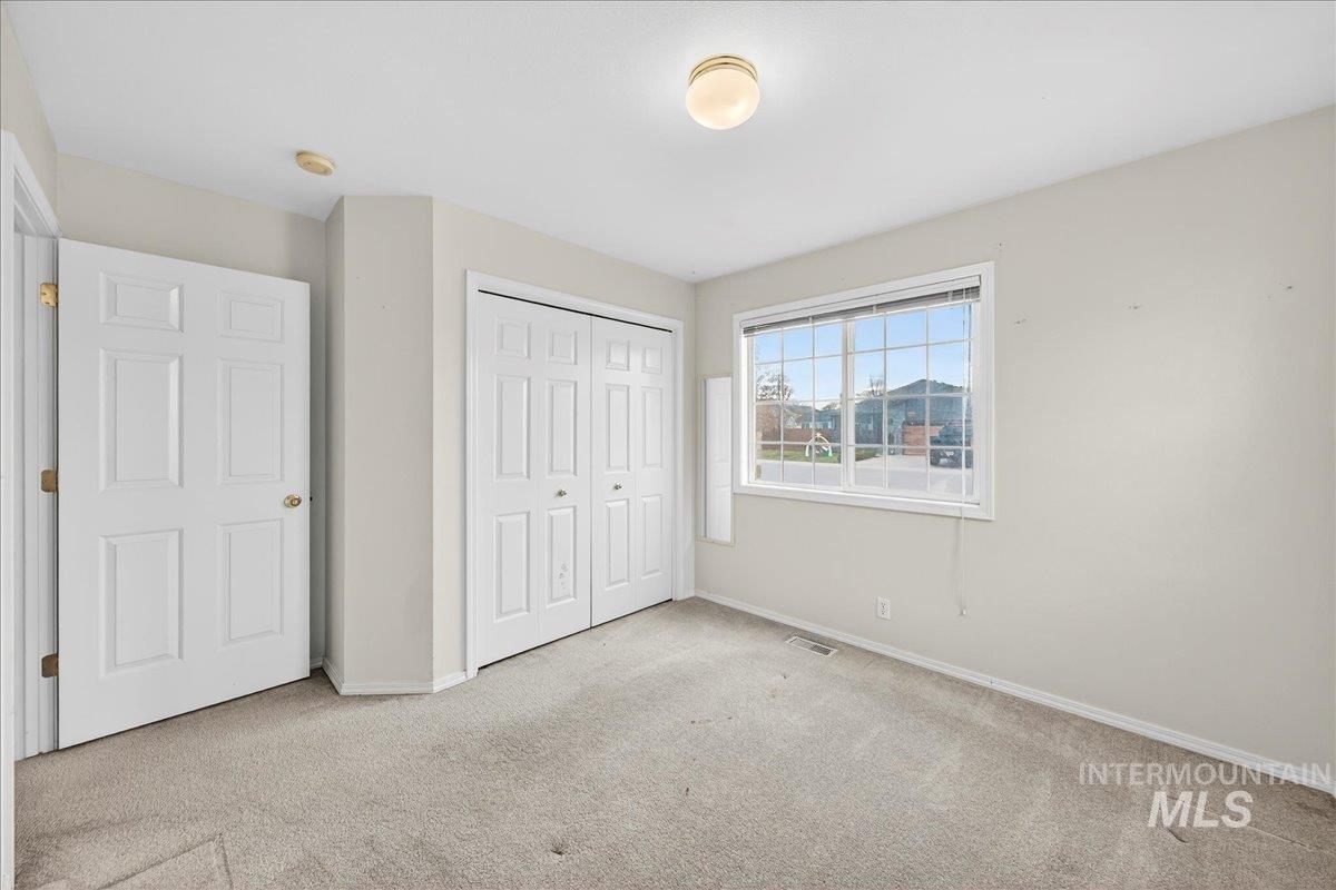 Unfurnished bedroom featuring a closet and carpet