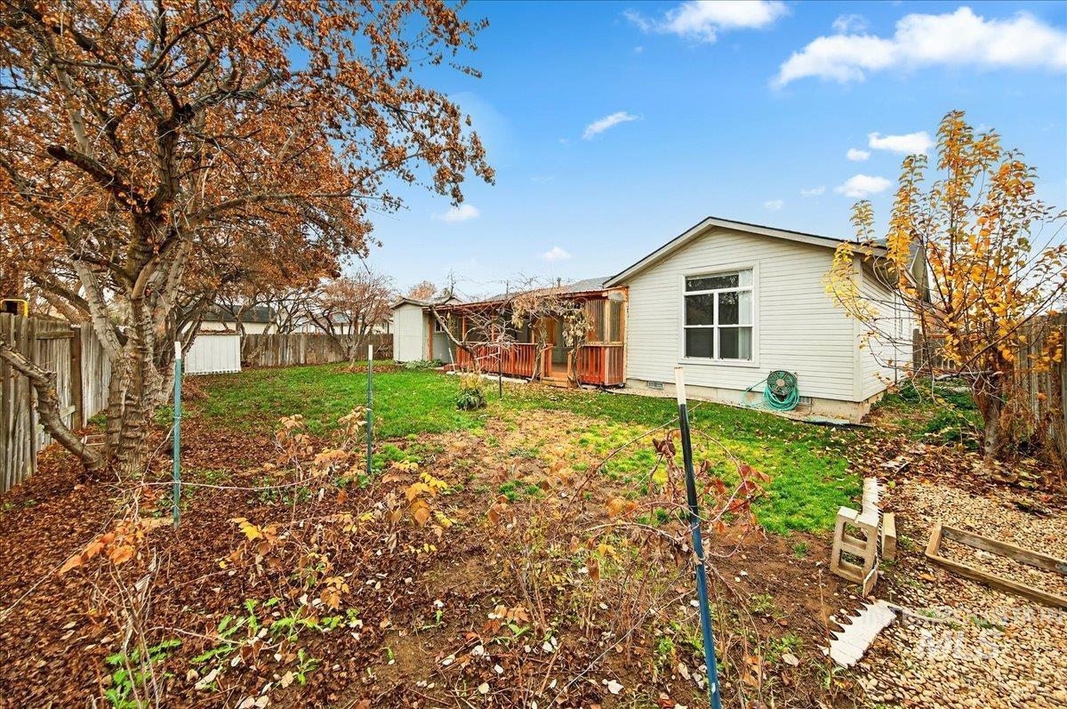 Rear view of house with a fenced backyard
