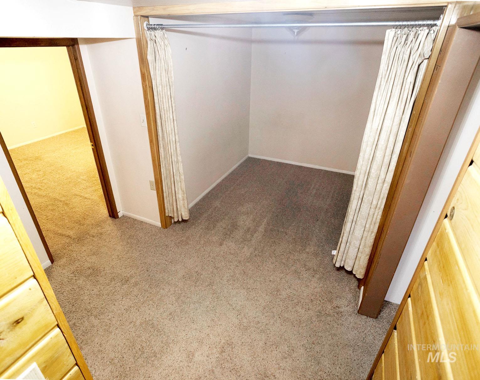 Corridor featuring light carpet