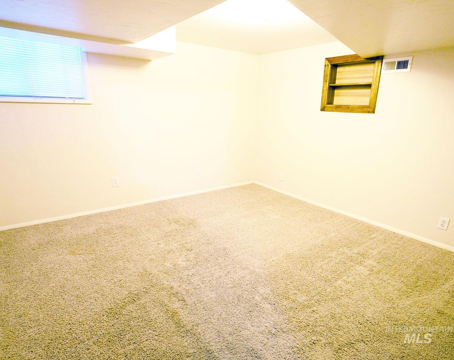 Basement featuring carpet and baseboards