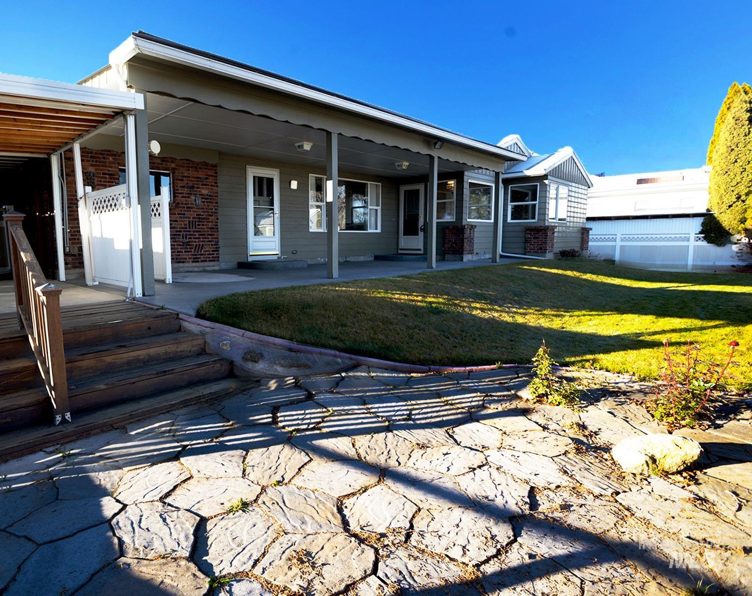 View of front facade featuring brick siding and a patio