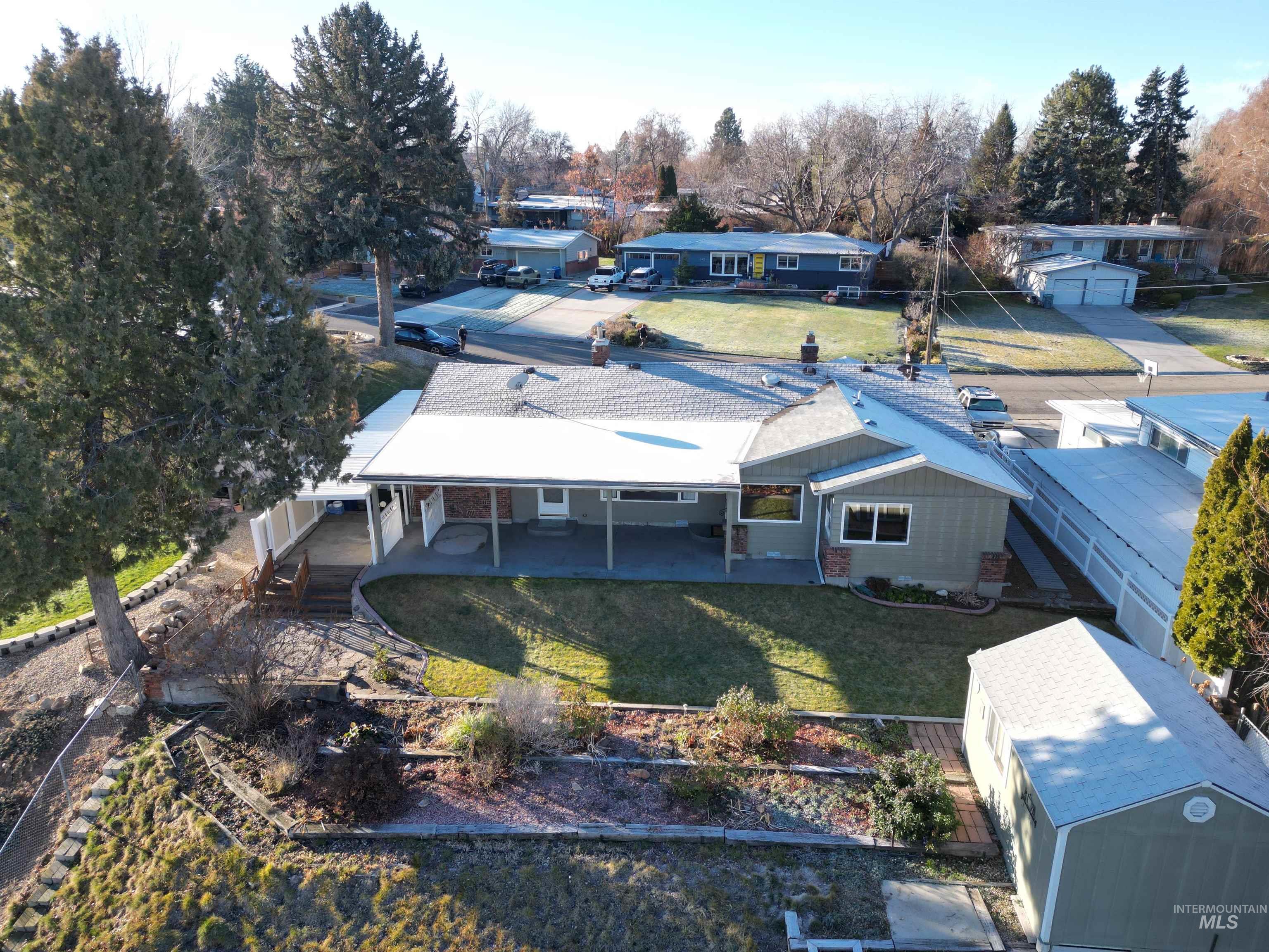 View from above of property with a tree filled landscape