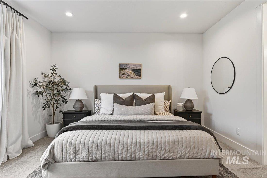 Bedroom with light colored carpet and recessed lighting