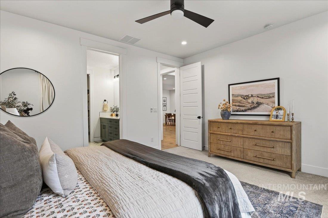Bedroom featuring light carpet, ensuite bath, a ceiling fan, and recessed lighting