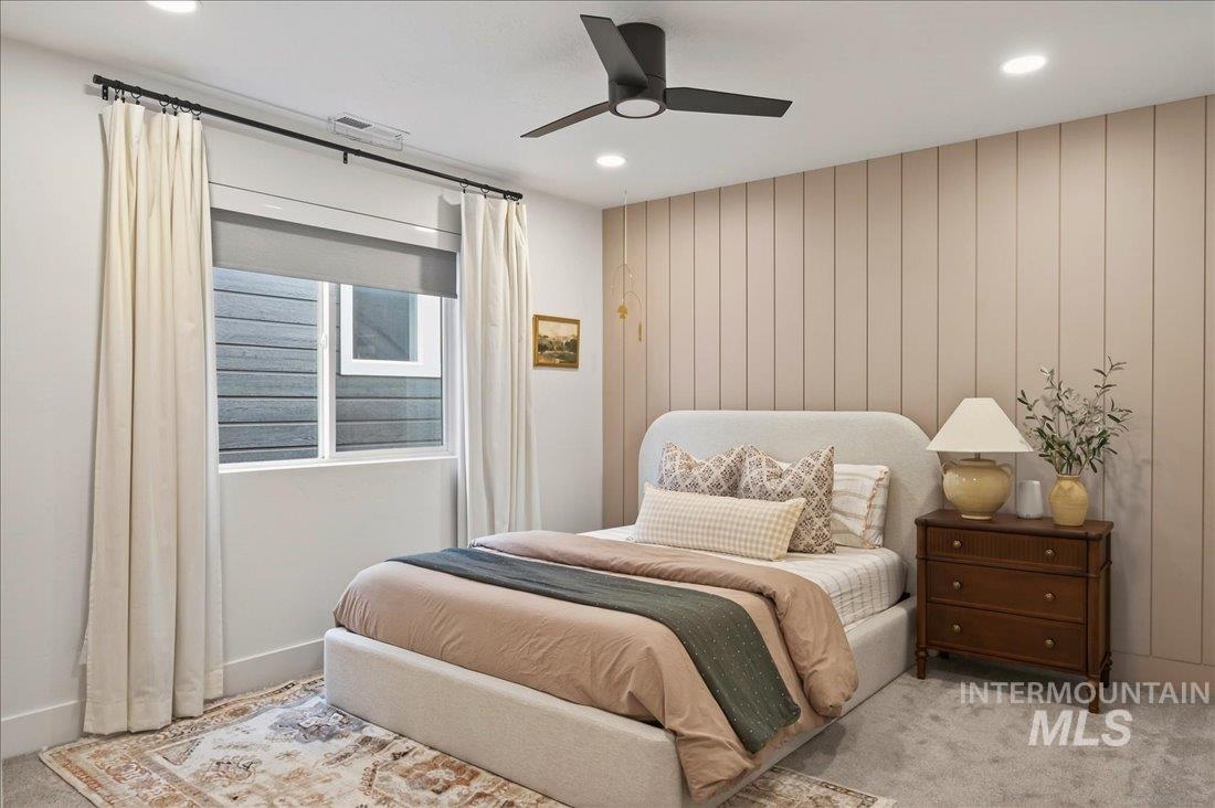 Carpeted bedroom featuring ceiling fan and recessed lighting