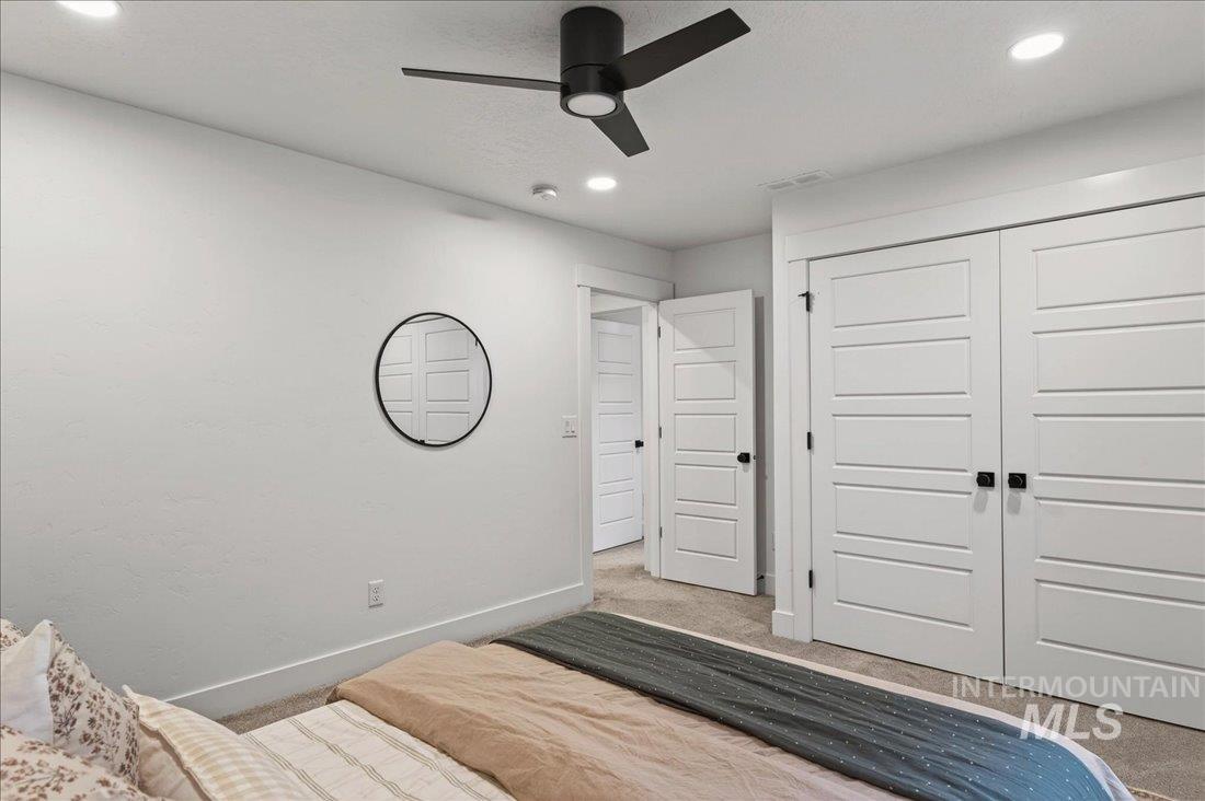 Unfurnished bedroom featuring carpet, a closet, ceiling fan, and recessed lighting