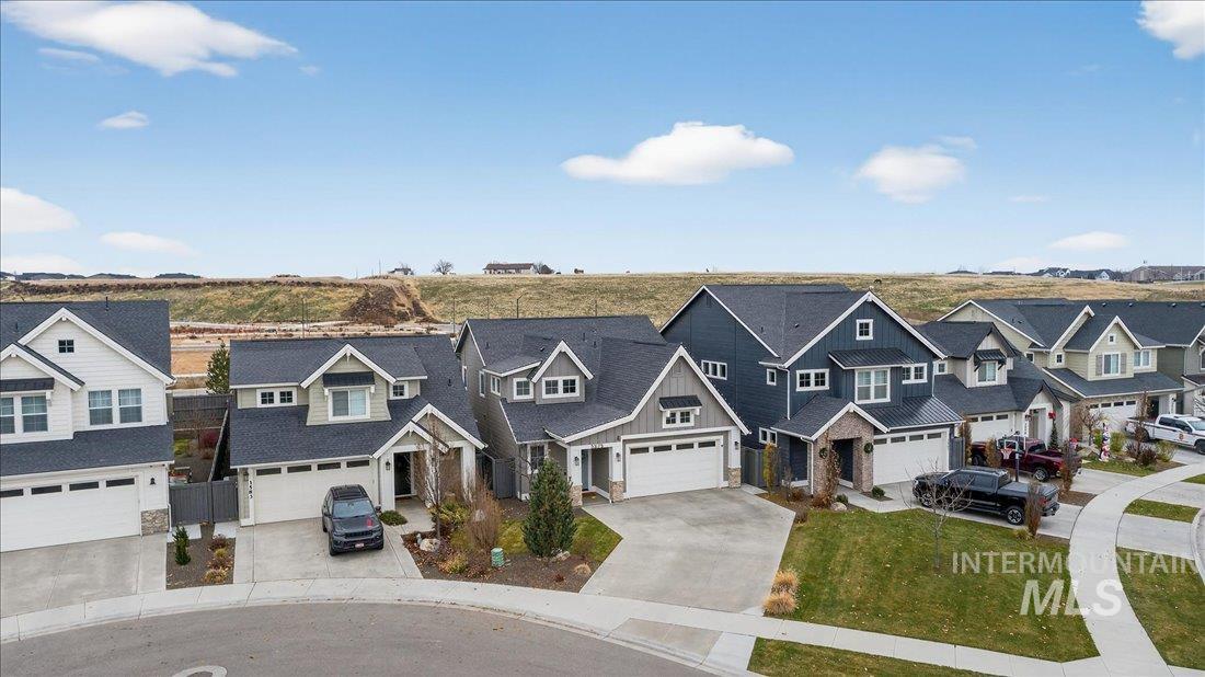 Craftsman inspired home with a residential view, concrete driveway, and a garage