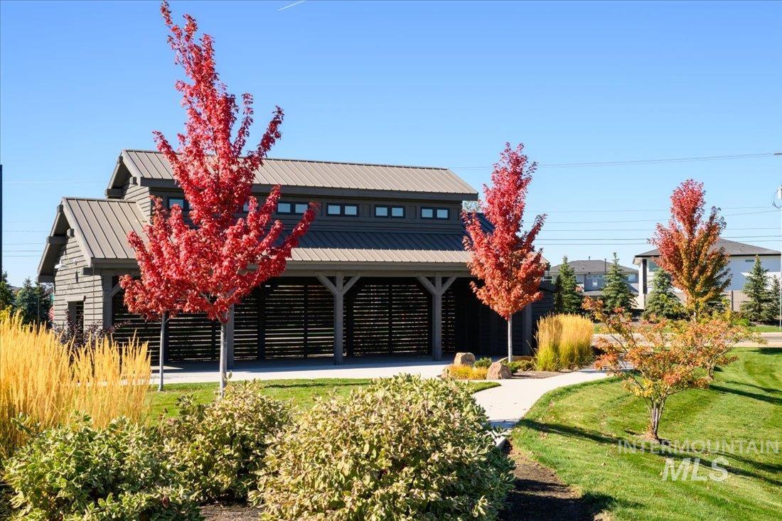 View of front of property featuring a metal roof and a front lawn