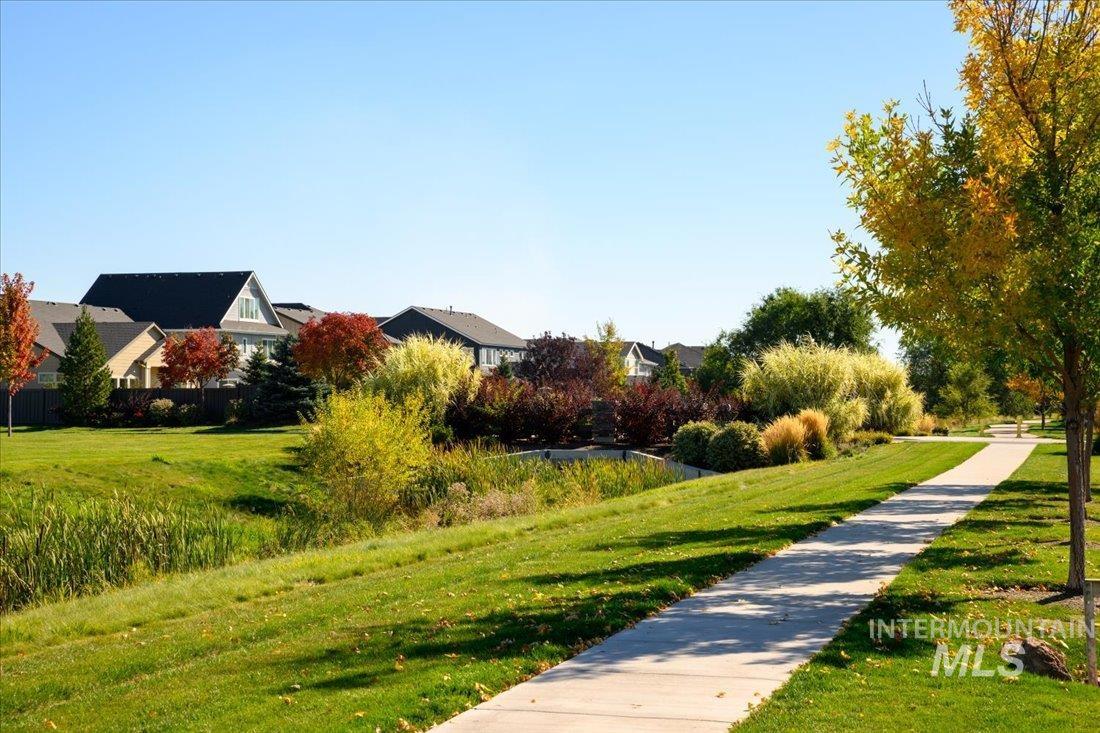 Surrounding community with a lawn and a residential view