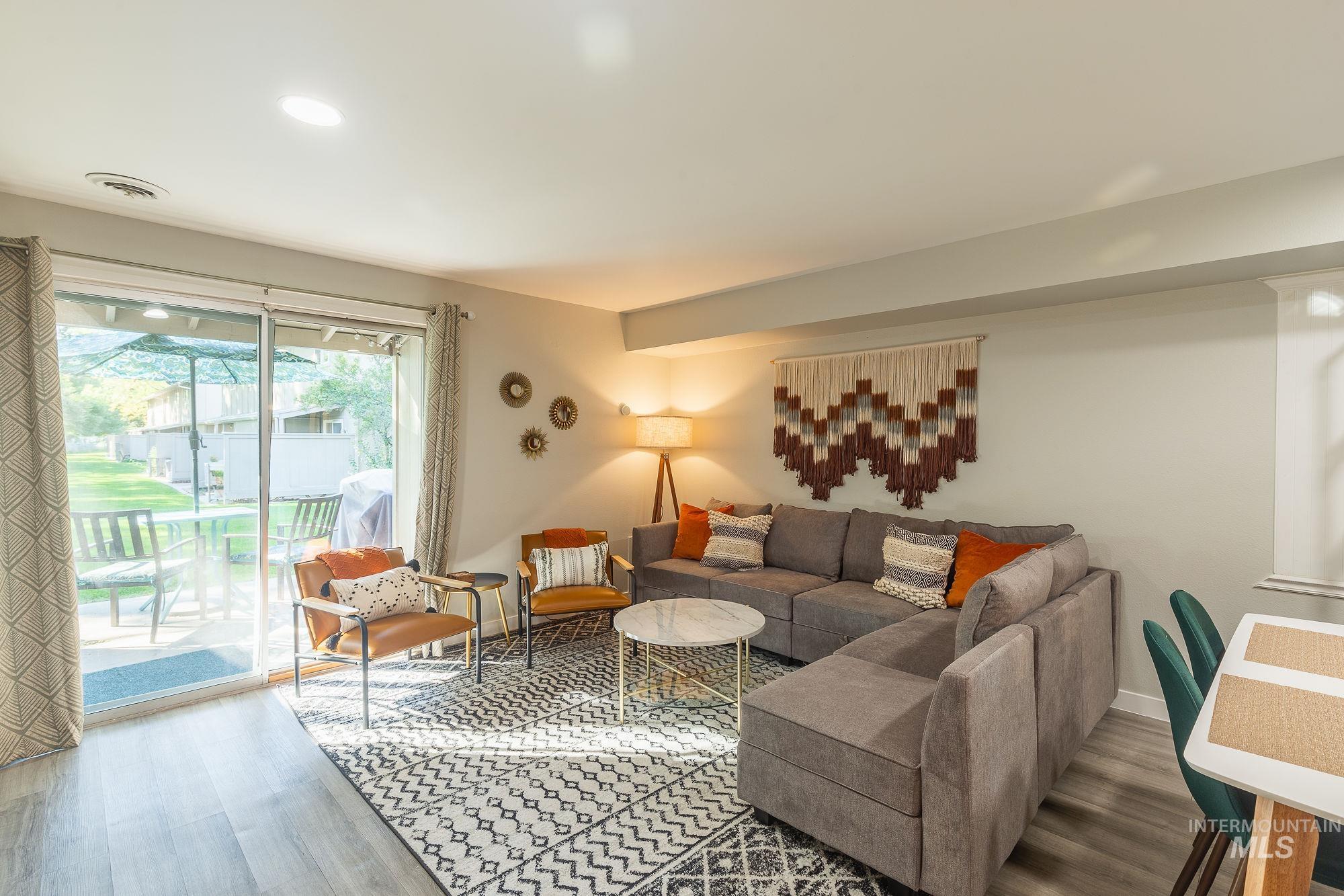 Living room with wood finished floors and recessed lighting