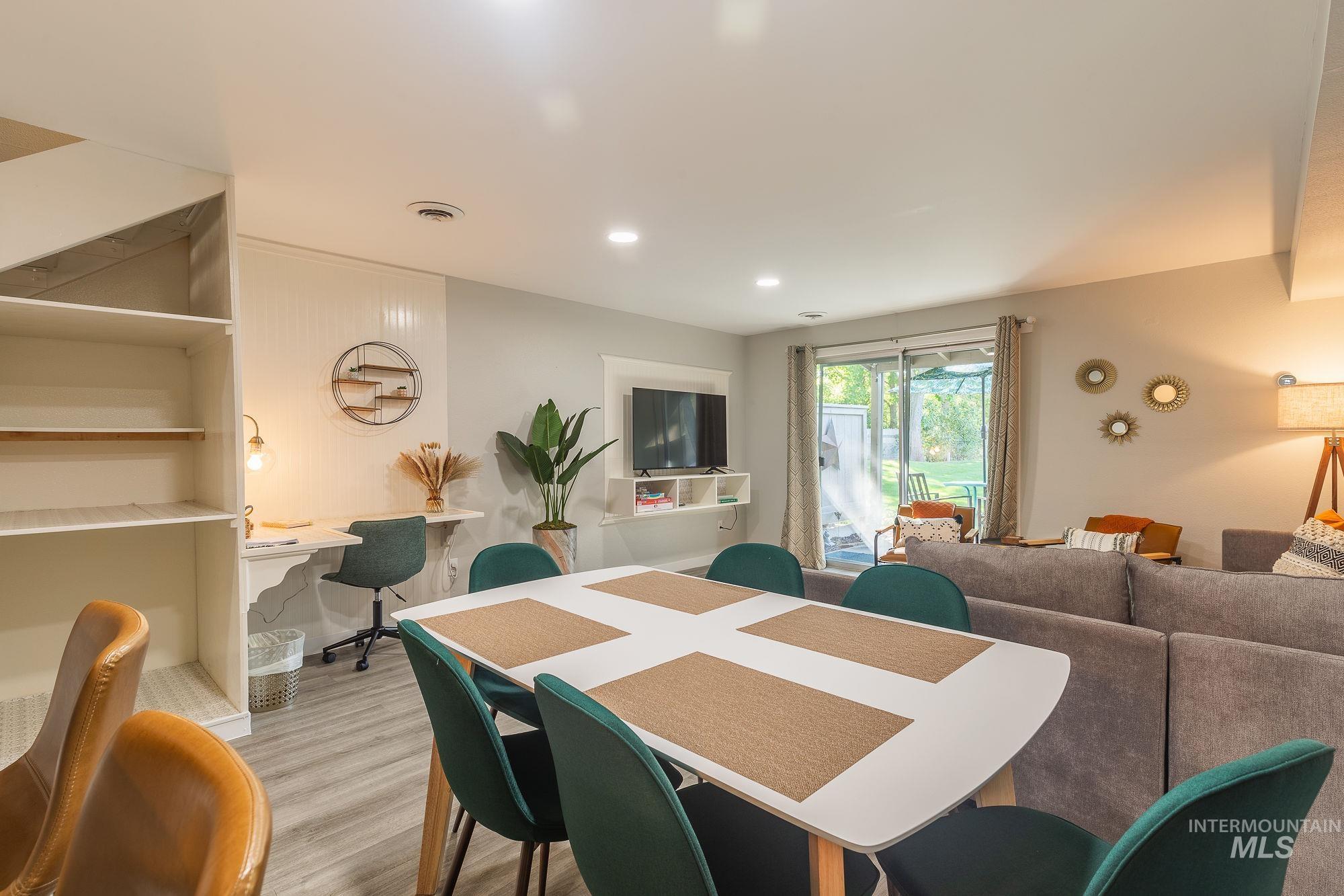 Dining space featuring light wood finished floors, recessed lighting, and a desk