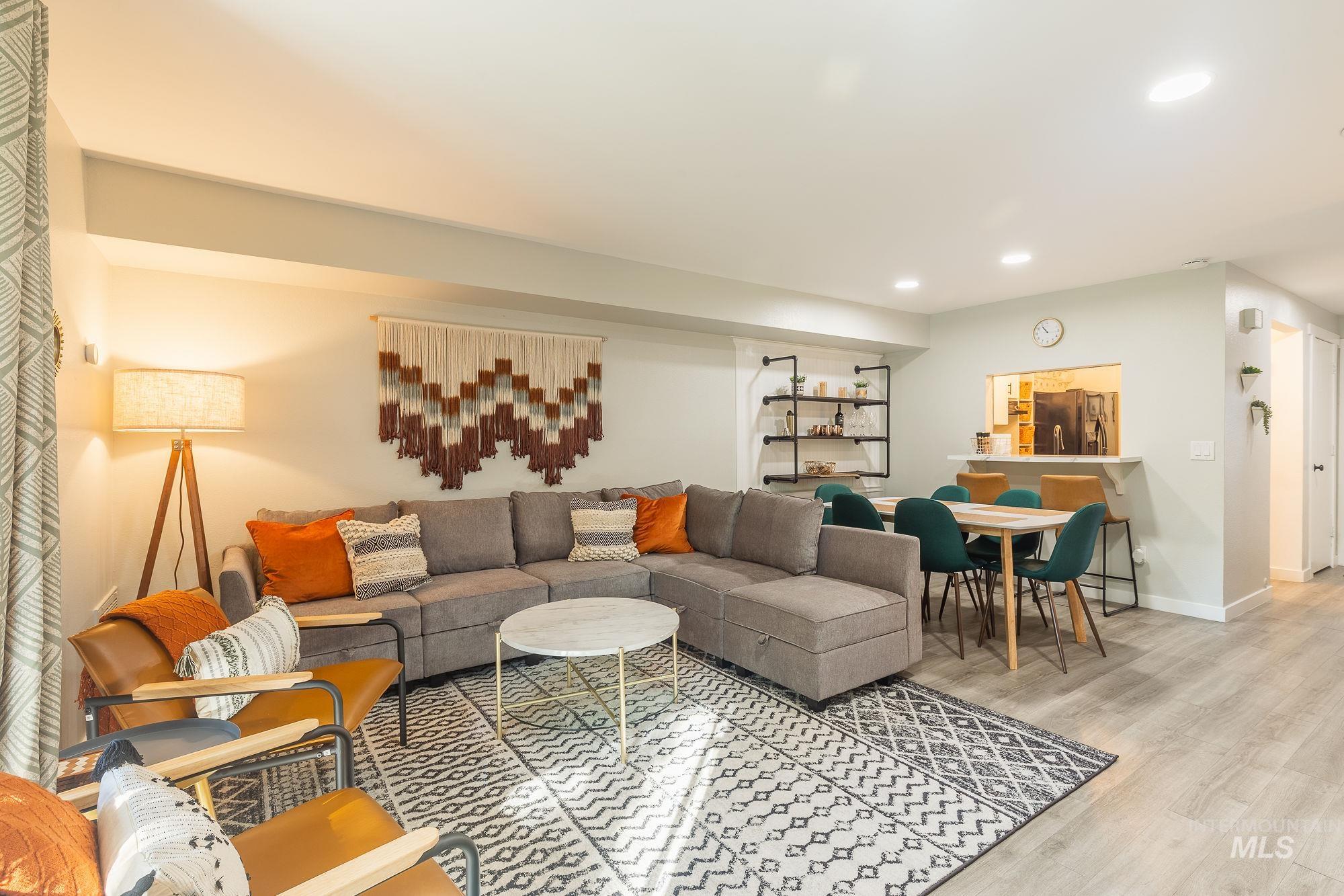 Living area with recessed lighting and light wood-style flooring
