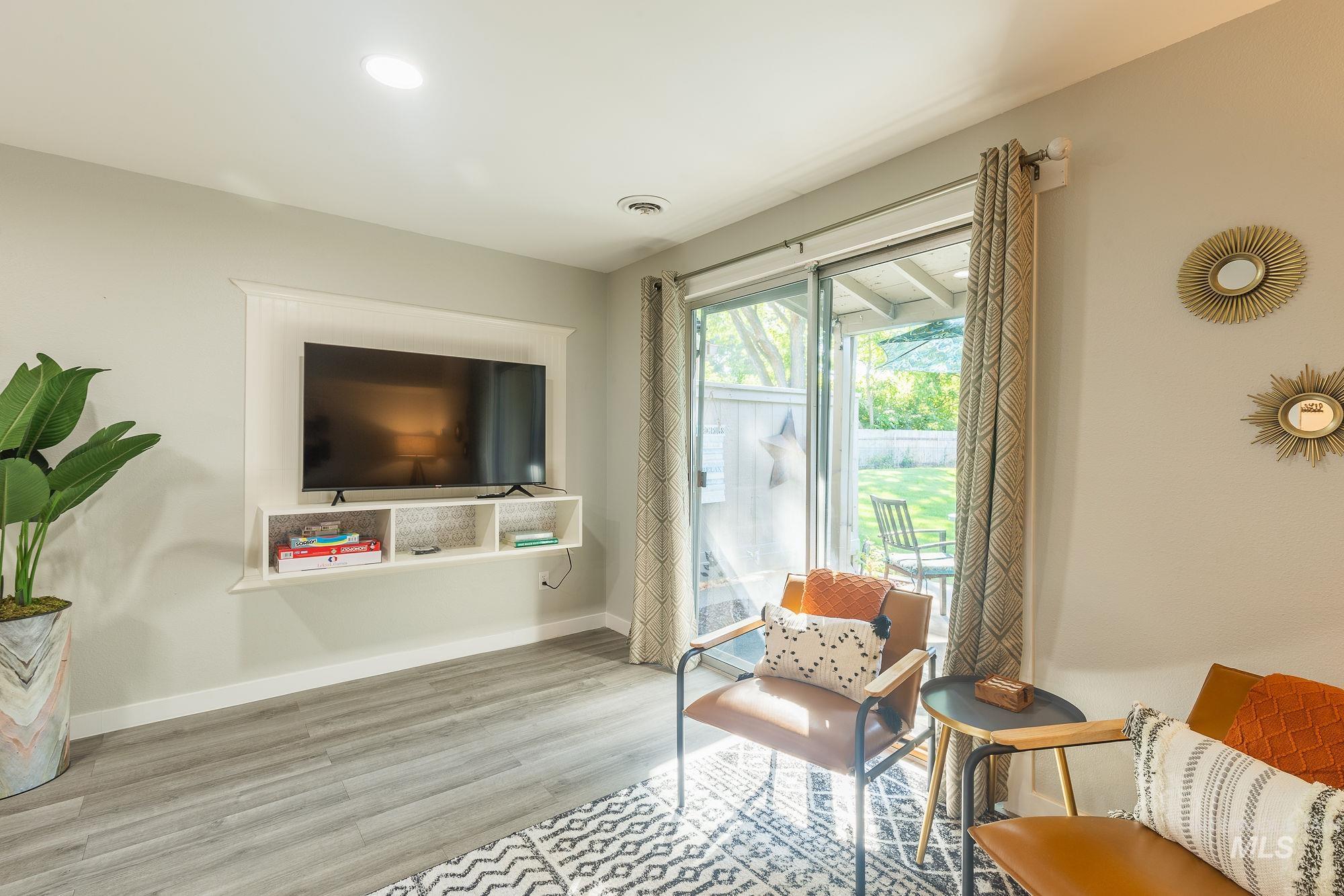 Living area with wood finished floors and baseboards