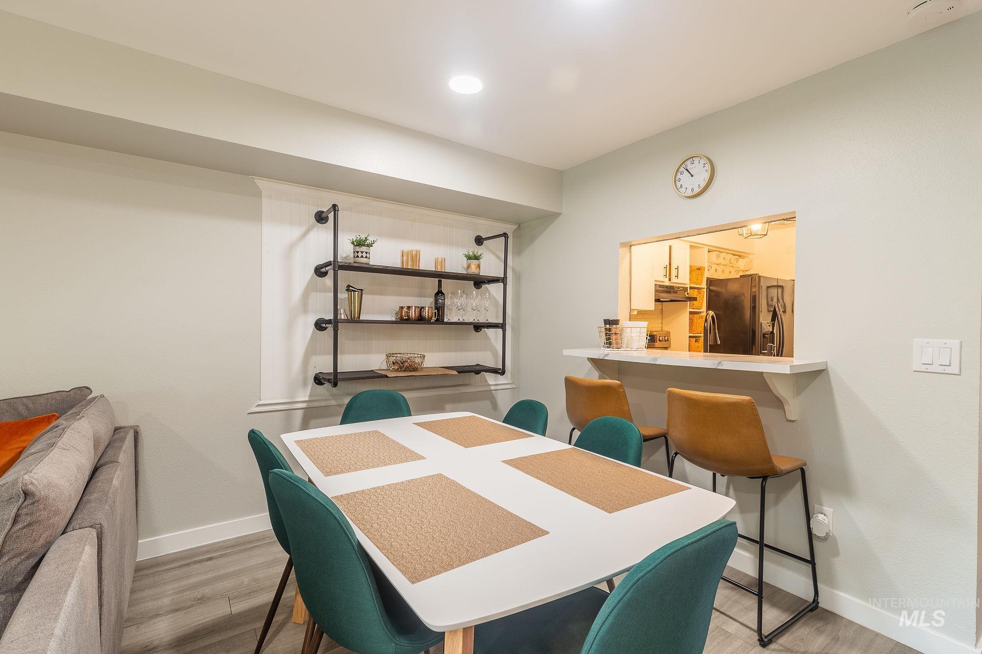 Dining space with light wood finished floors and baseboards