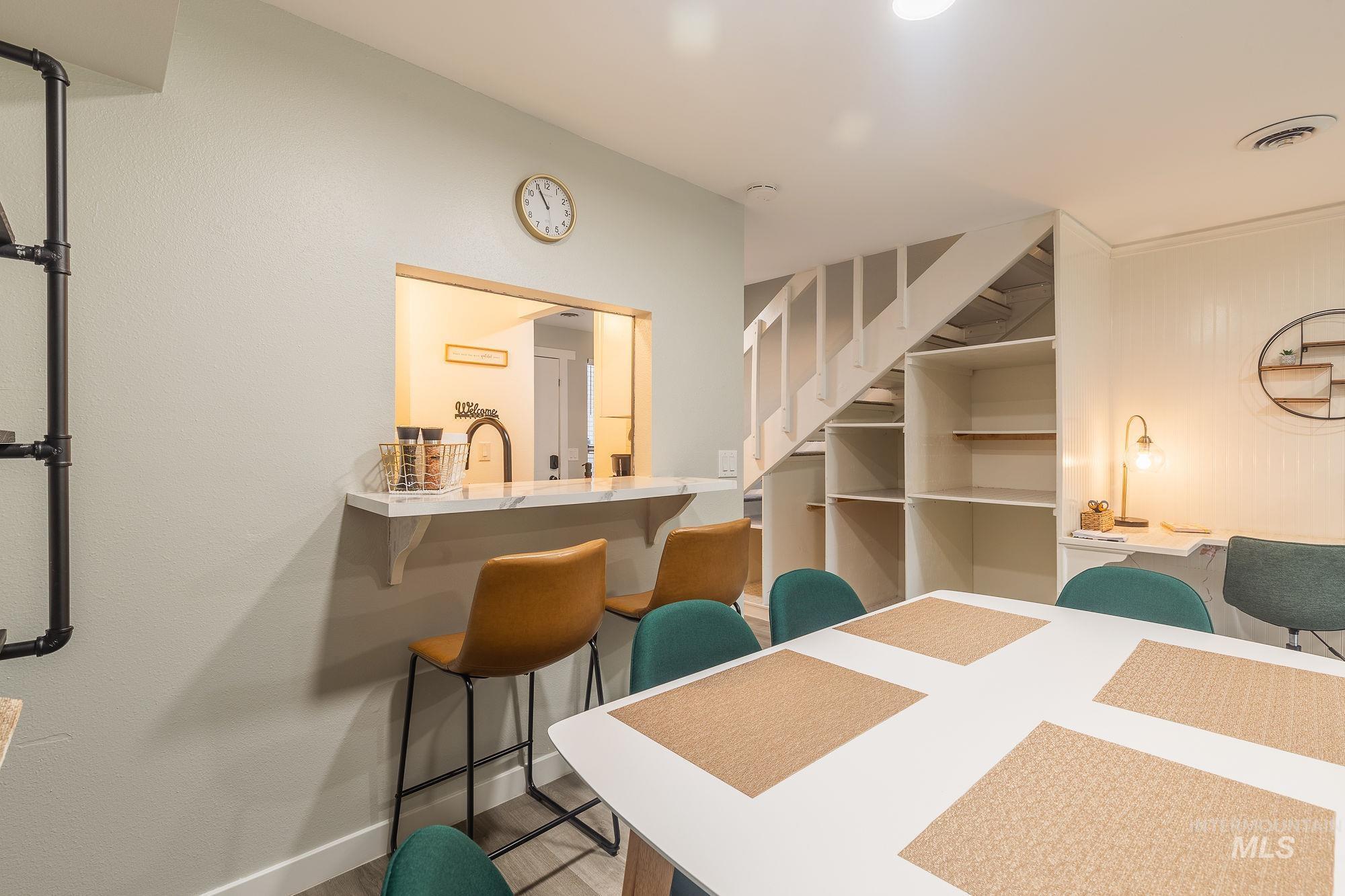 Dining space featuring baseboards and wood finished floors