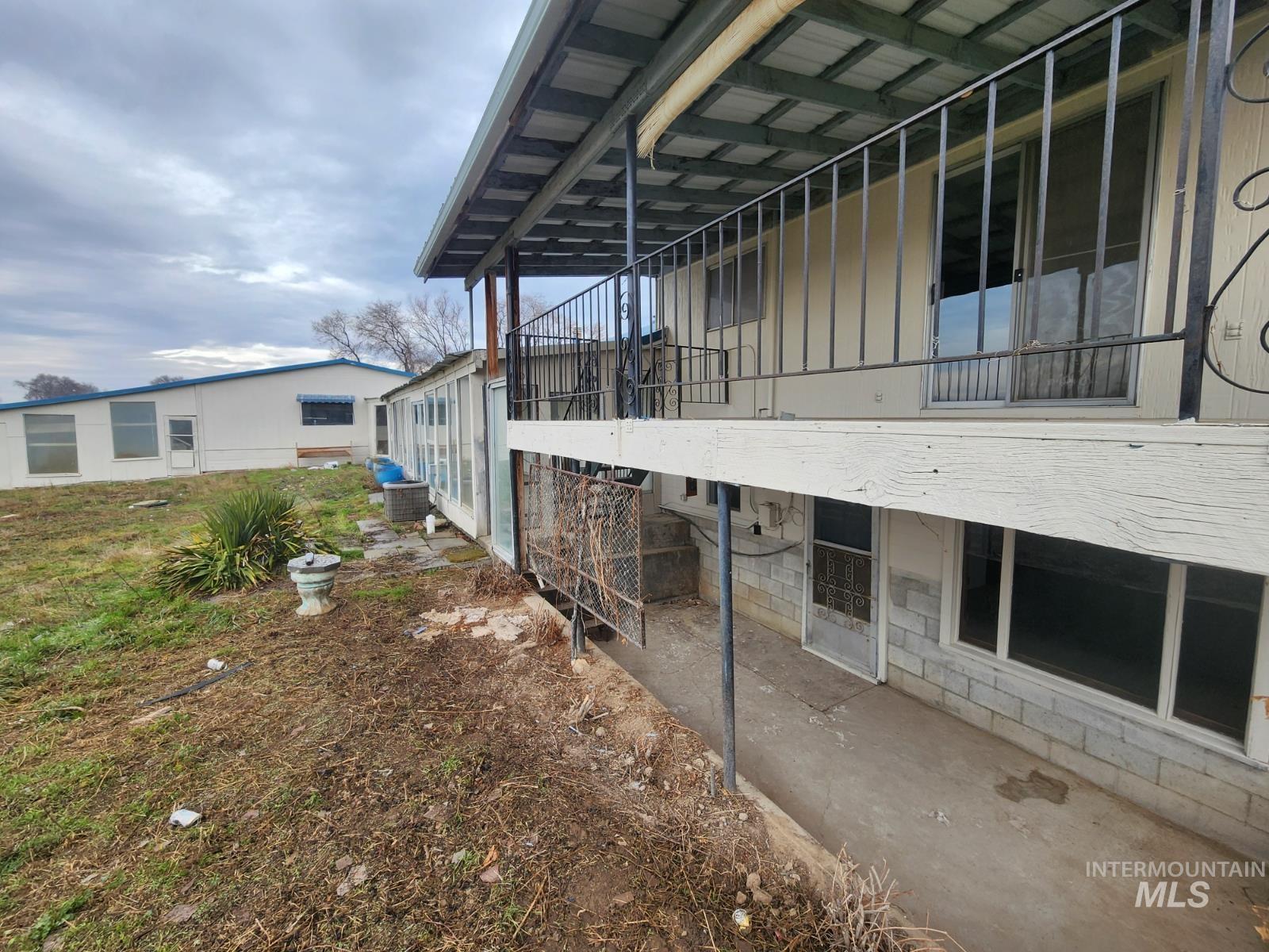 View of property exterior featuring a patio area and a balcony