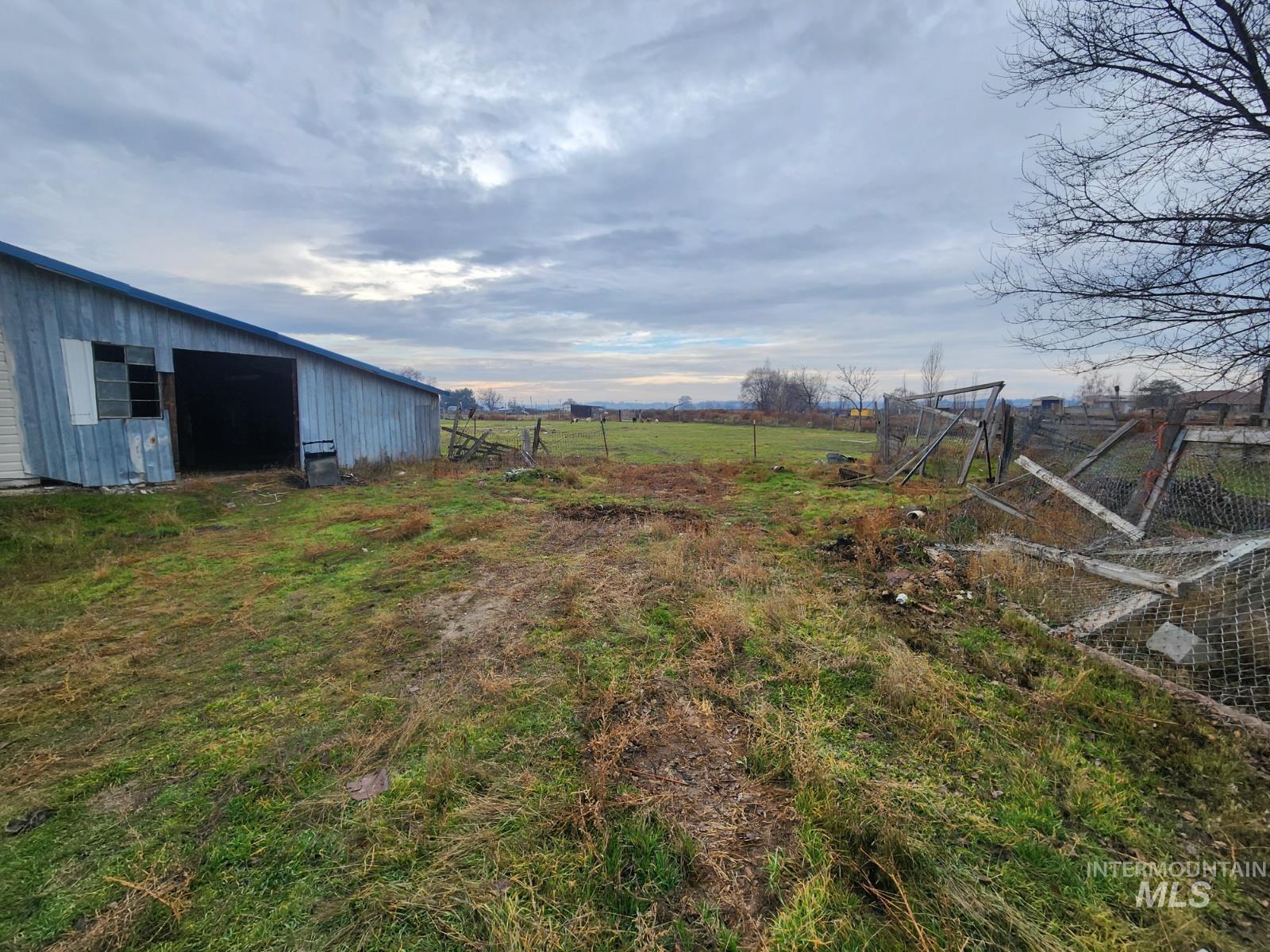 View of yard with a view of rural / pastoral area, an outdoor structure, and an outbuilding