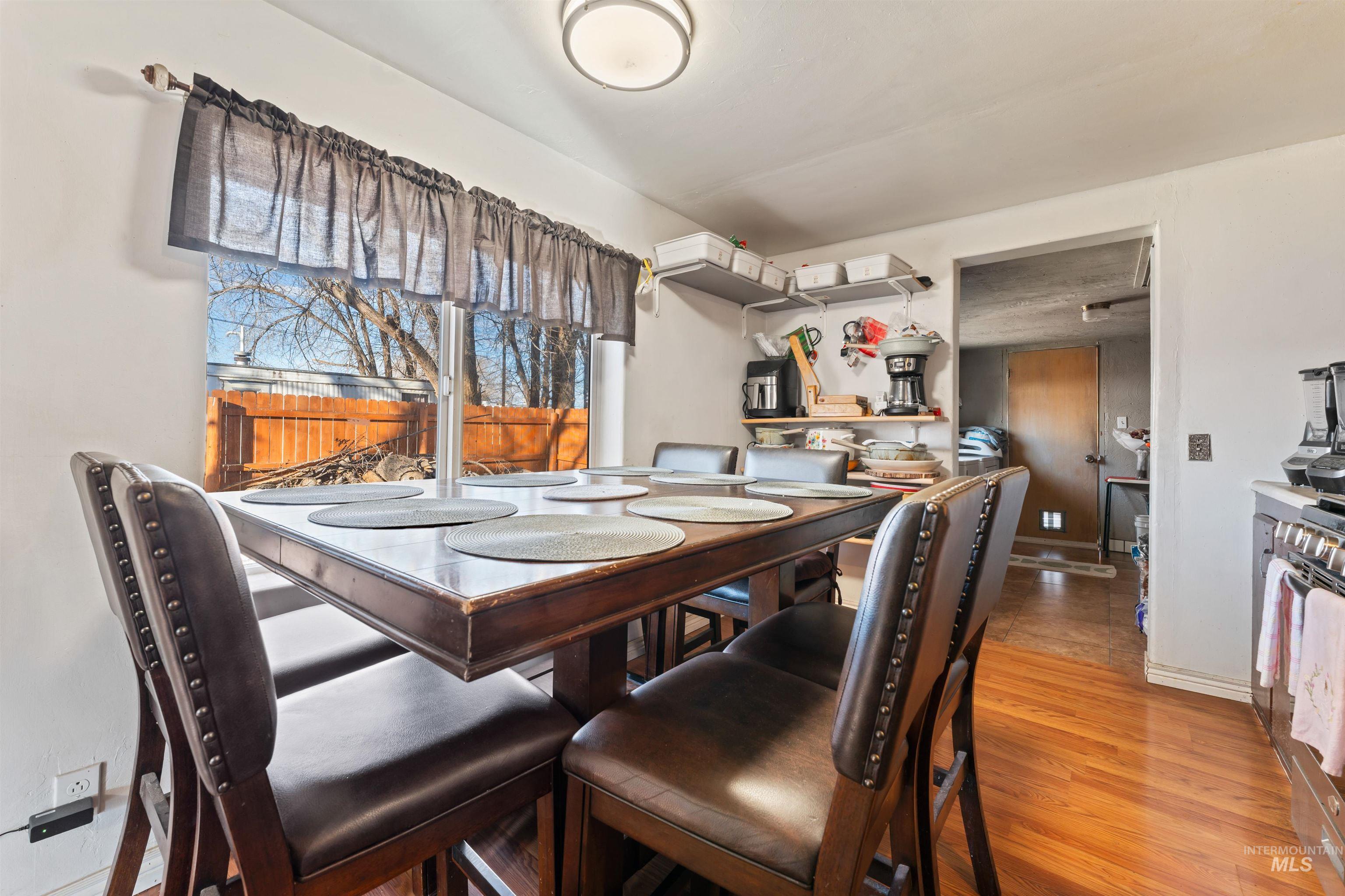 Dining space featuring light wood-type flooring and baseboards