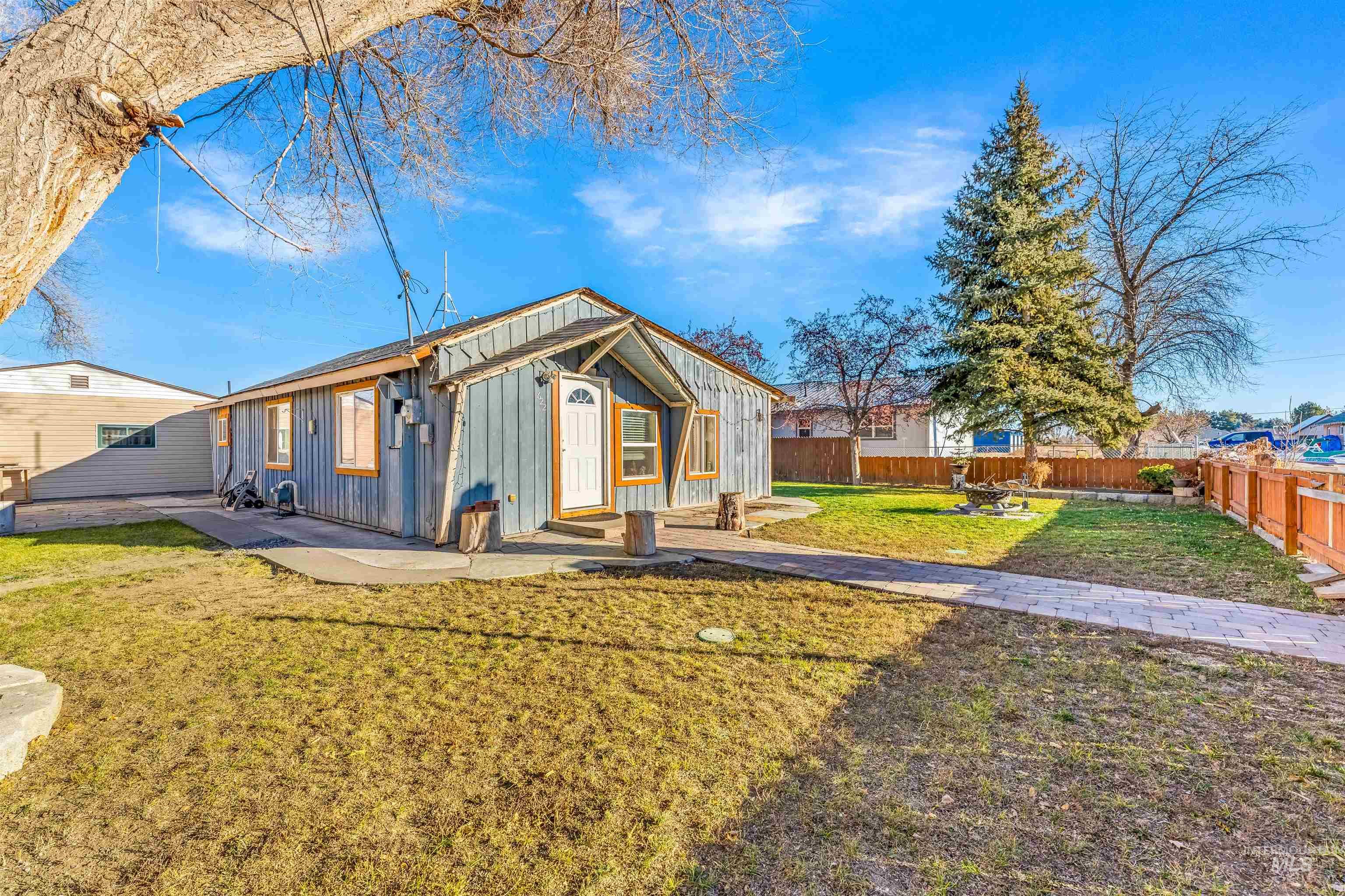 View of front of property featuring board and batten siding and a fenced backyard