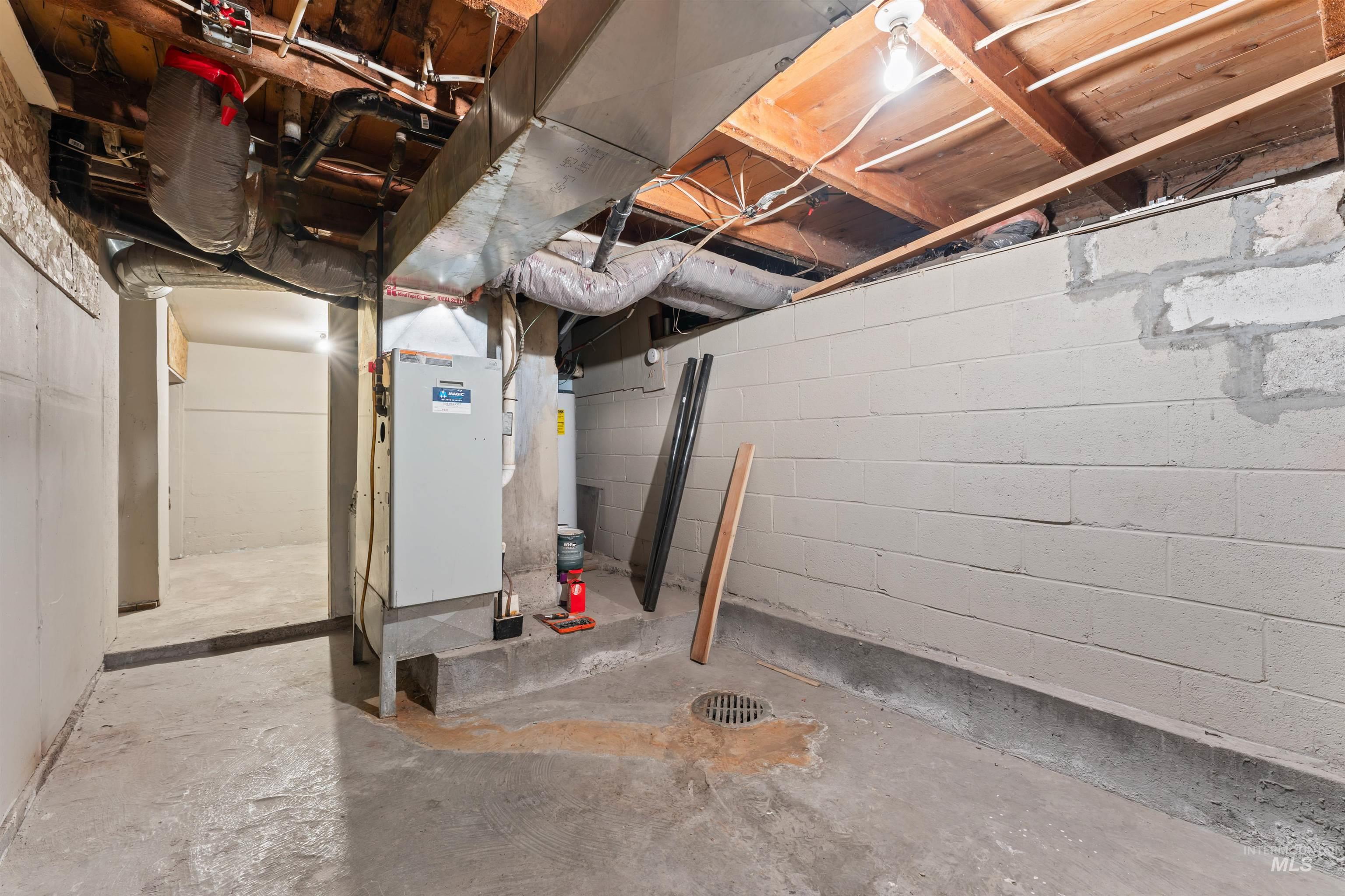Unfinished basement featuring heating unit