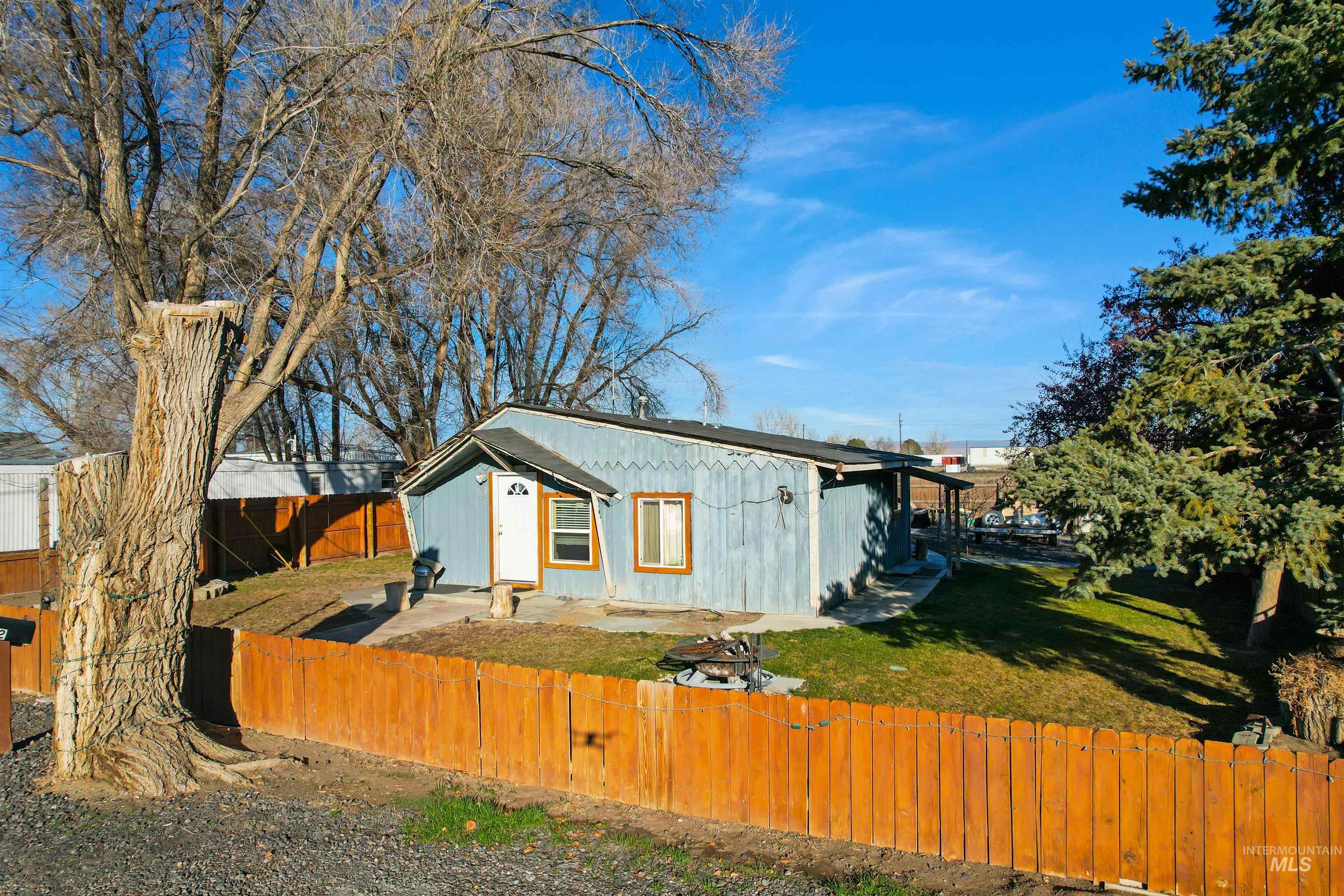 View of side of home featuring a fenced backyard and a patio