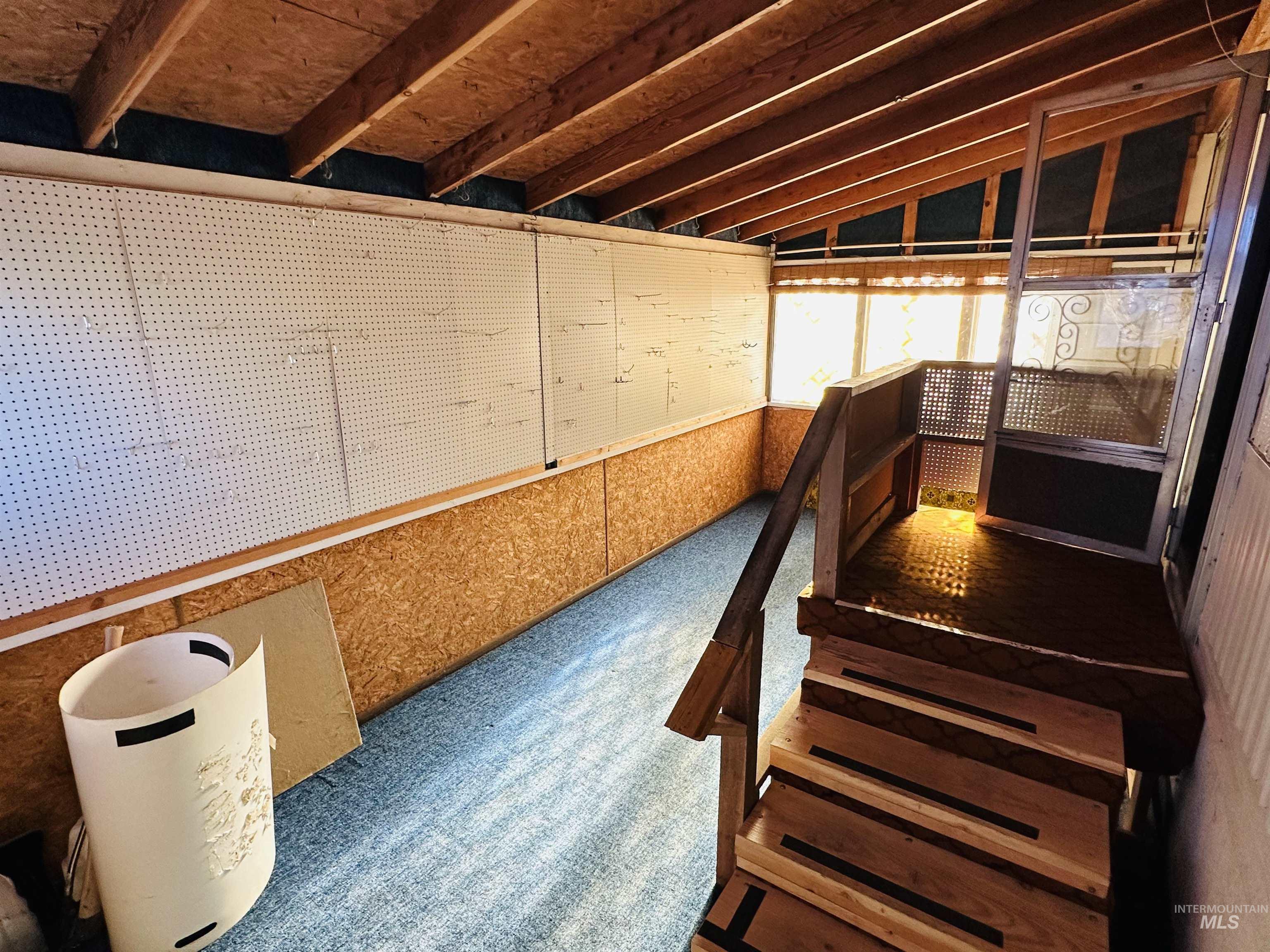 Misc room featuring vaulted ceiling and carpet floors