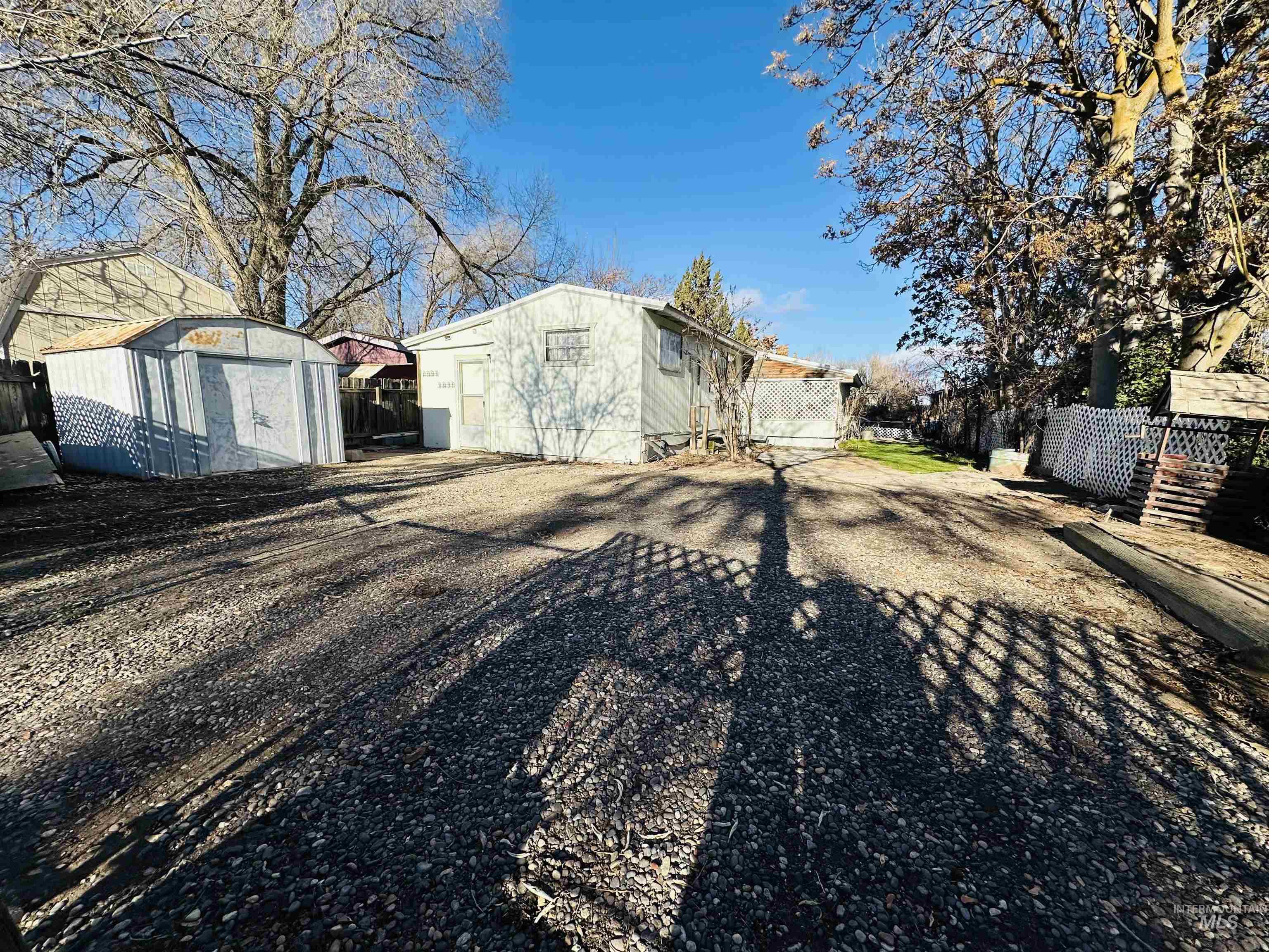 Rear view of house featuring a storage shed