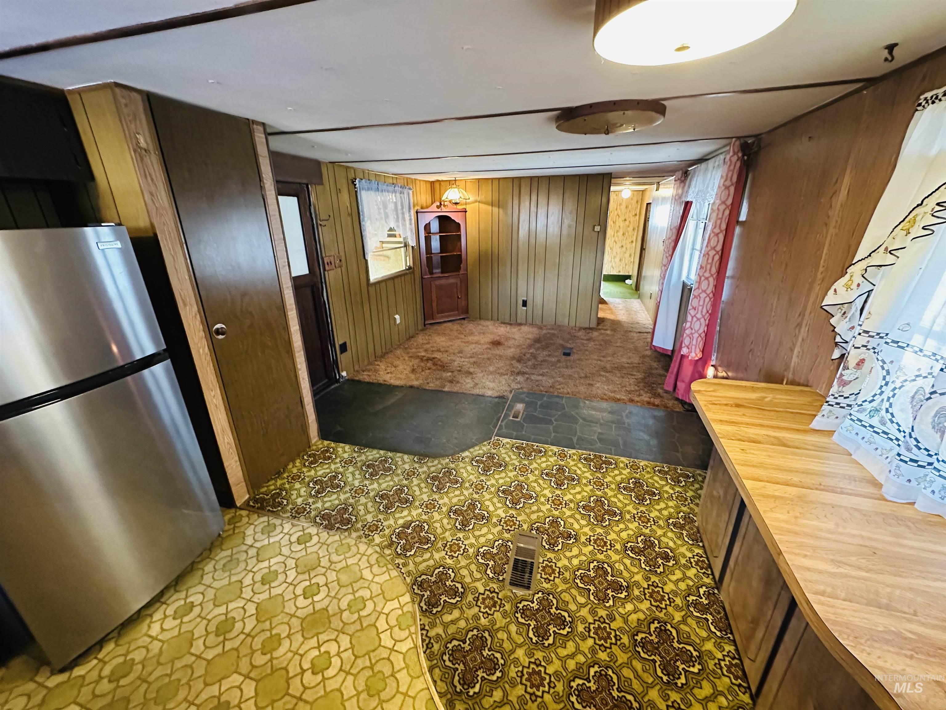 Entrance foyer featuring wood walls and tile patterned floors