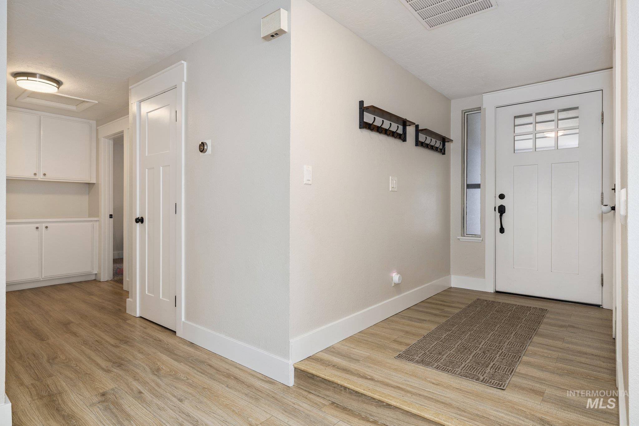 Entrance foyer featuring light wood-style floors