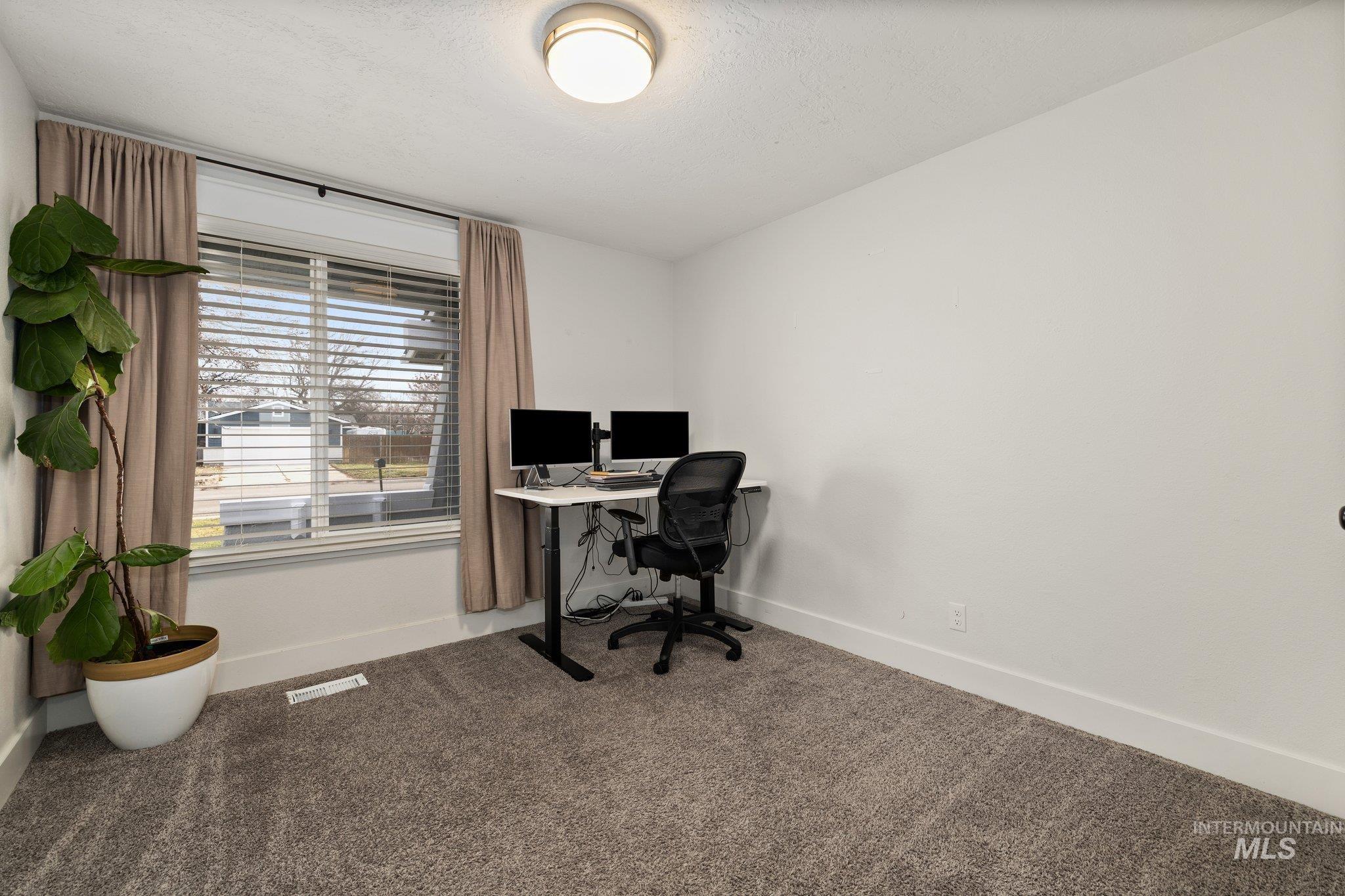 Office featuring baseboards and carpet floors