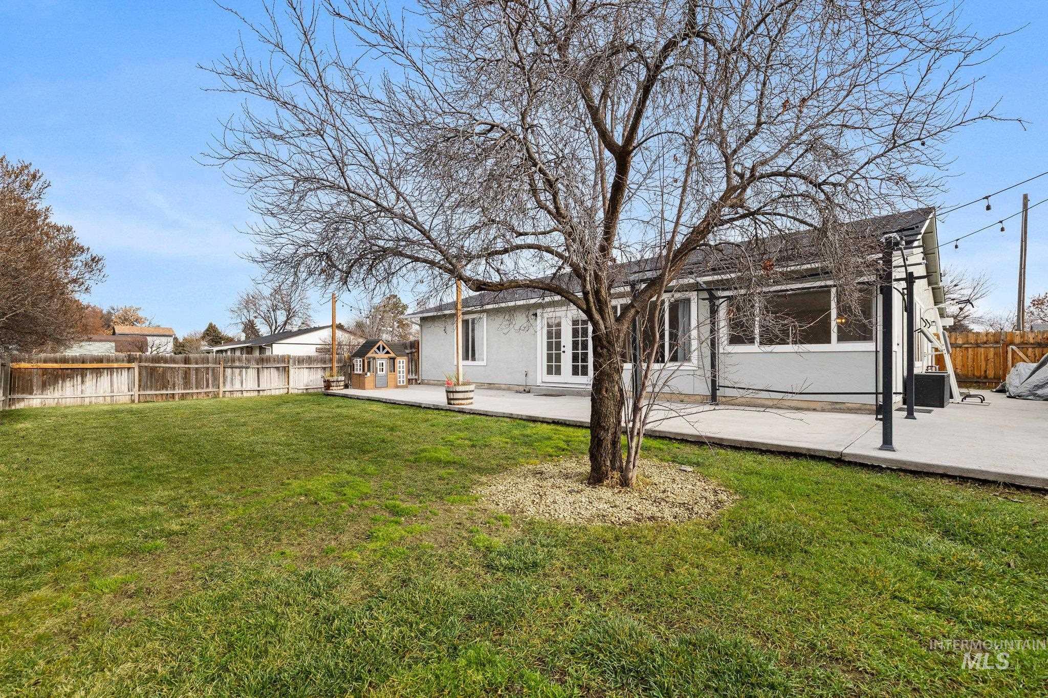 Rear view of house with a patio, a fenced backyard, french doors, and stucco siding