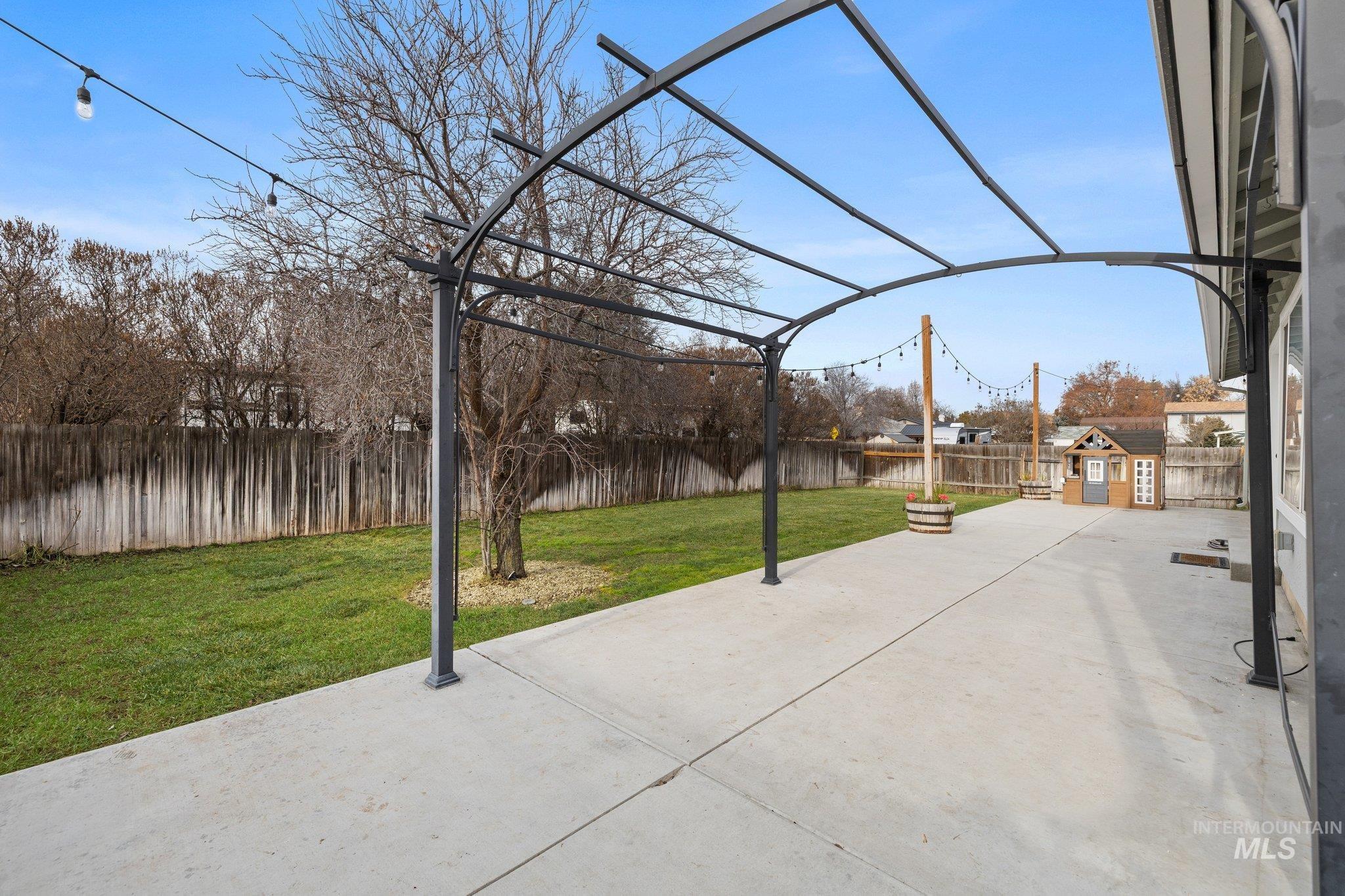 Fenced backyard with a patio area