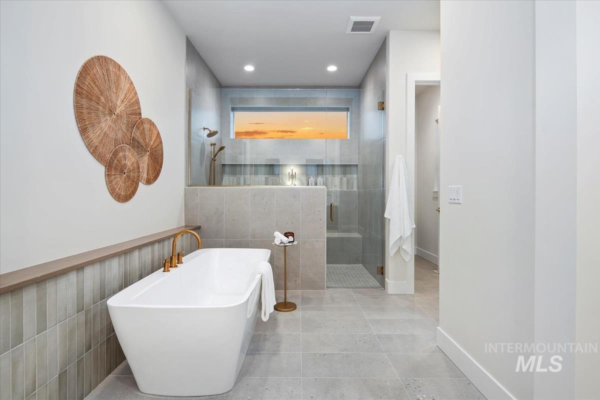 Full bathroom featuring a freestanding tub, a shower stall, recessed lighting, and tile patterned floors