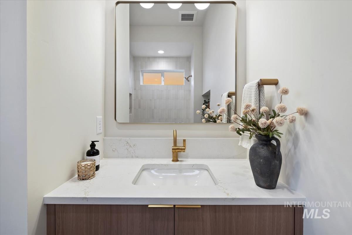 Full bath with vanity and a shower
