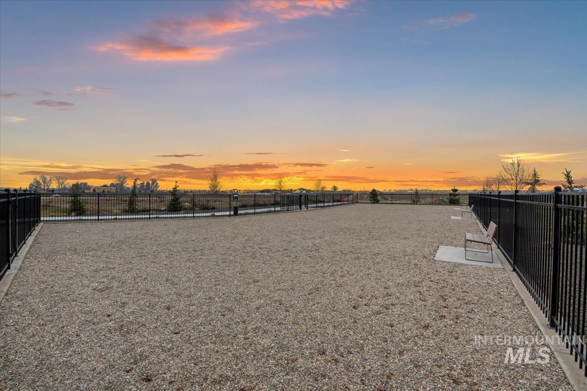 Yard at dusk with a fenced backyard