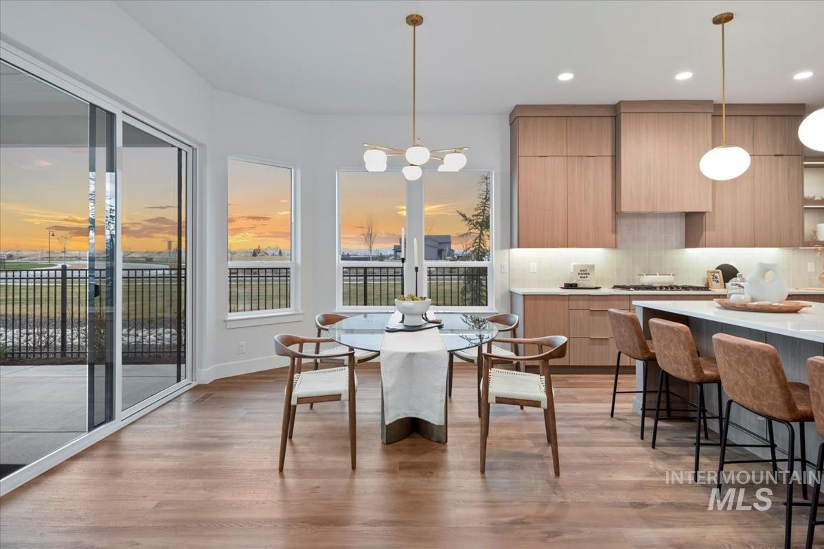 Dining space with light wood-type flooring and recessed lighting