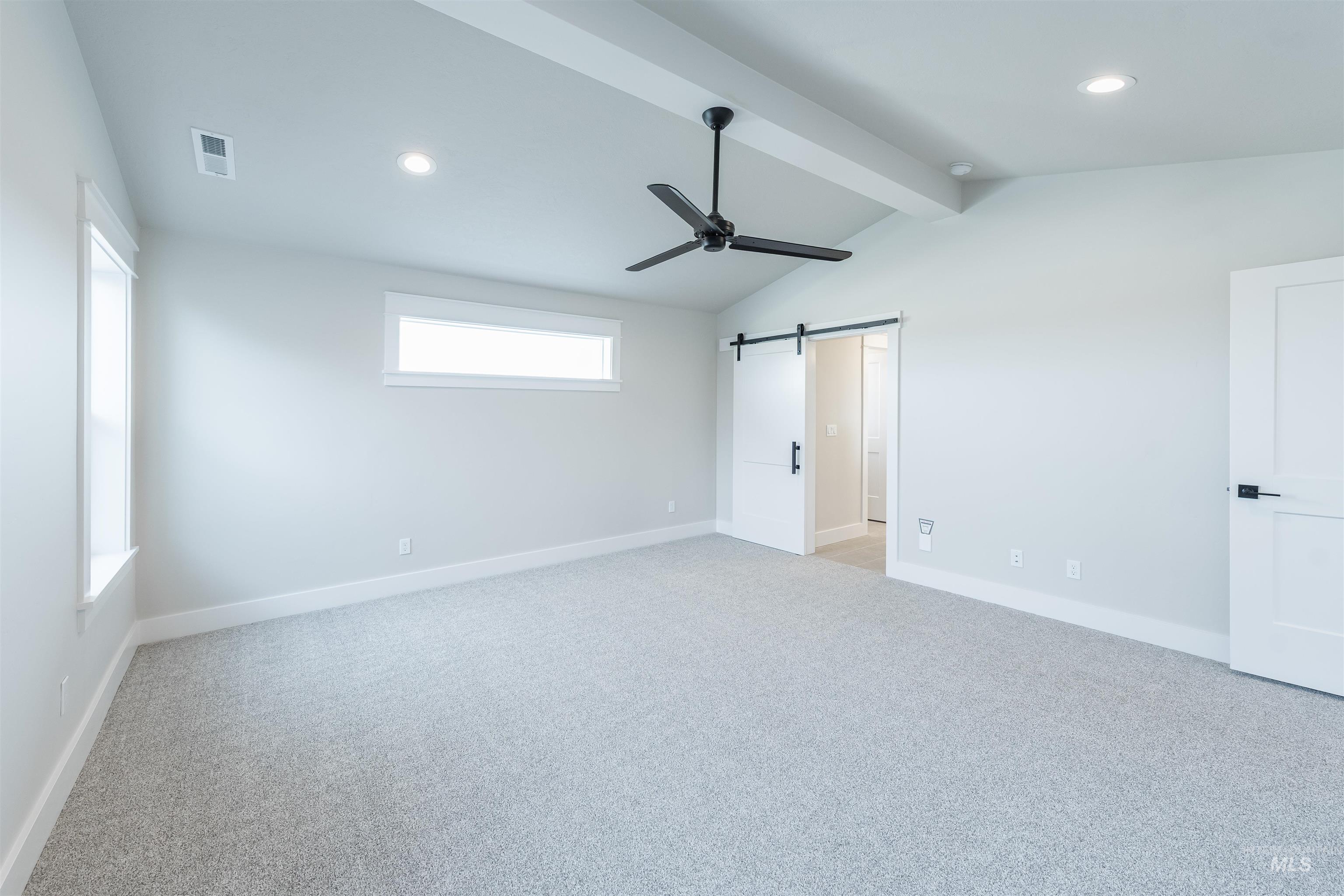 Unfurnished bedroom with a barn door, ceiling fan, light colored carpet, and recessed lighting