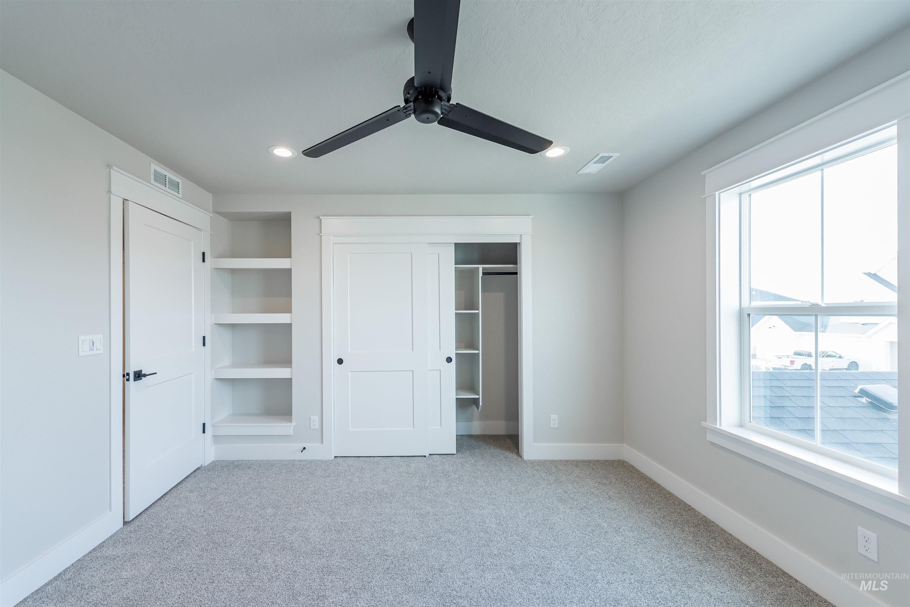 Unfurnished bedroom with a closet, ceiling fan, light carpet, and recessed lighting