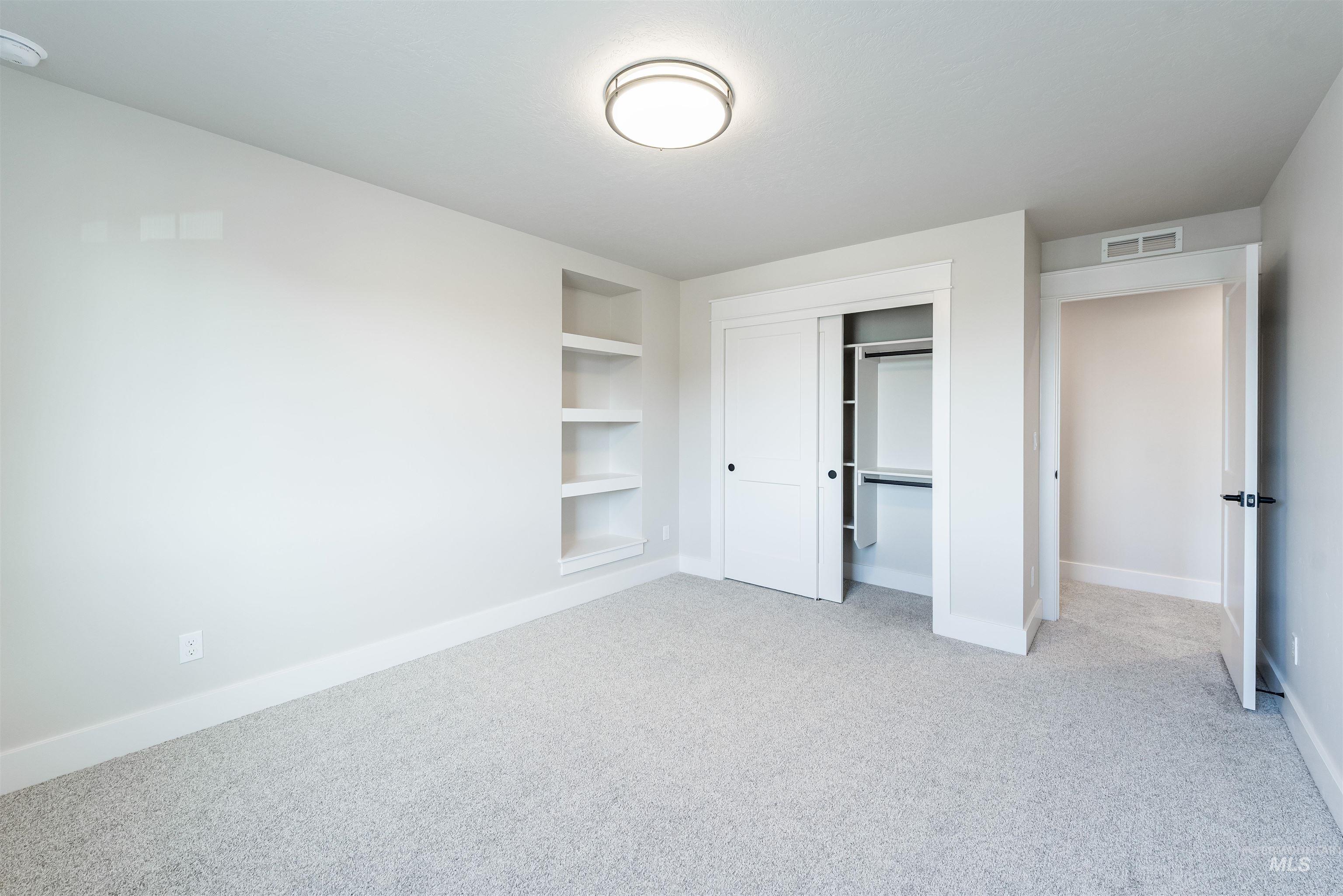 Unfurnished bedroom with a closet and light colored carpet