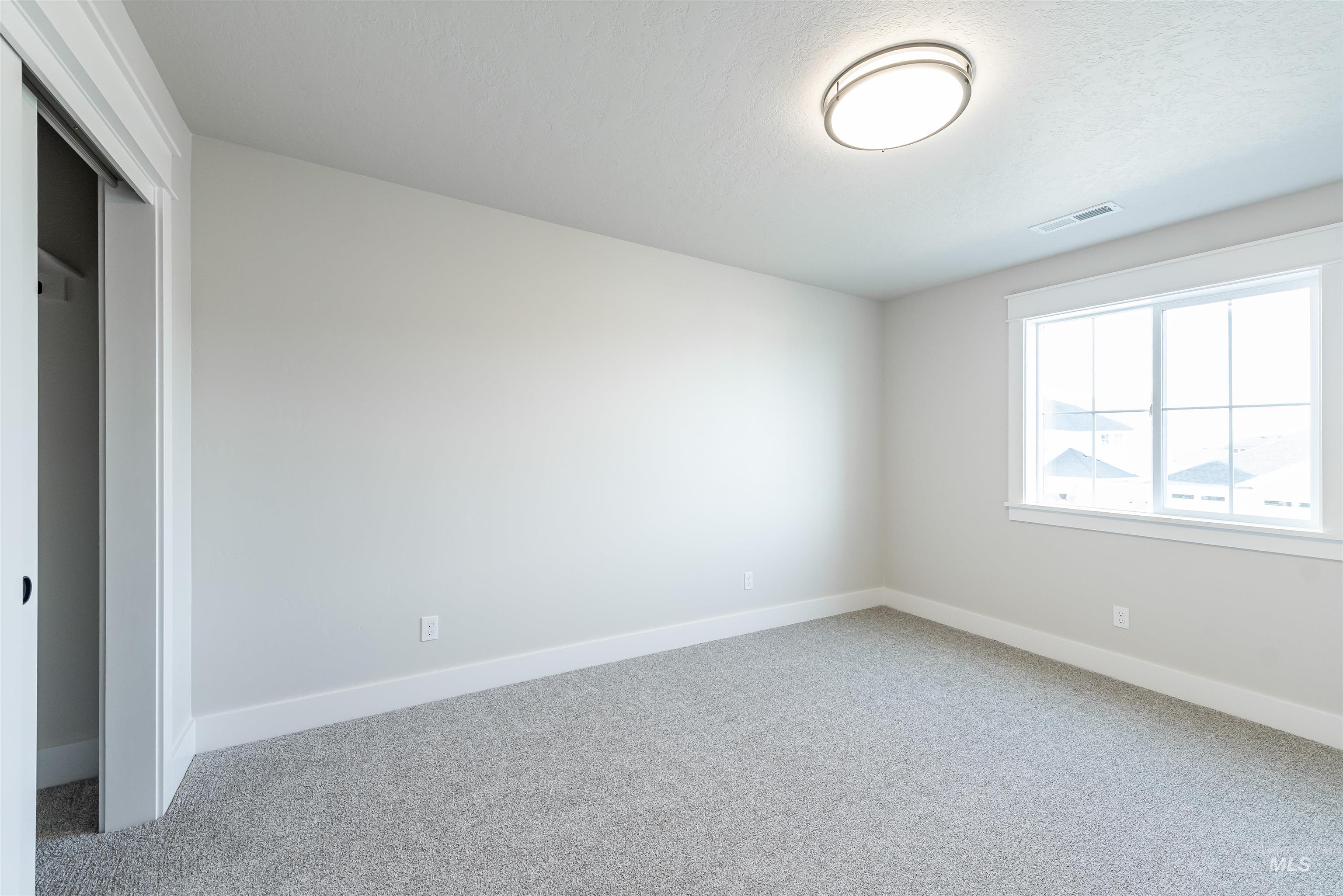 Unfurnished bedroom with a closet and carpet flooring