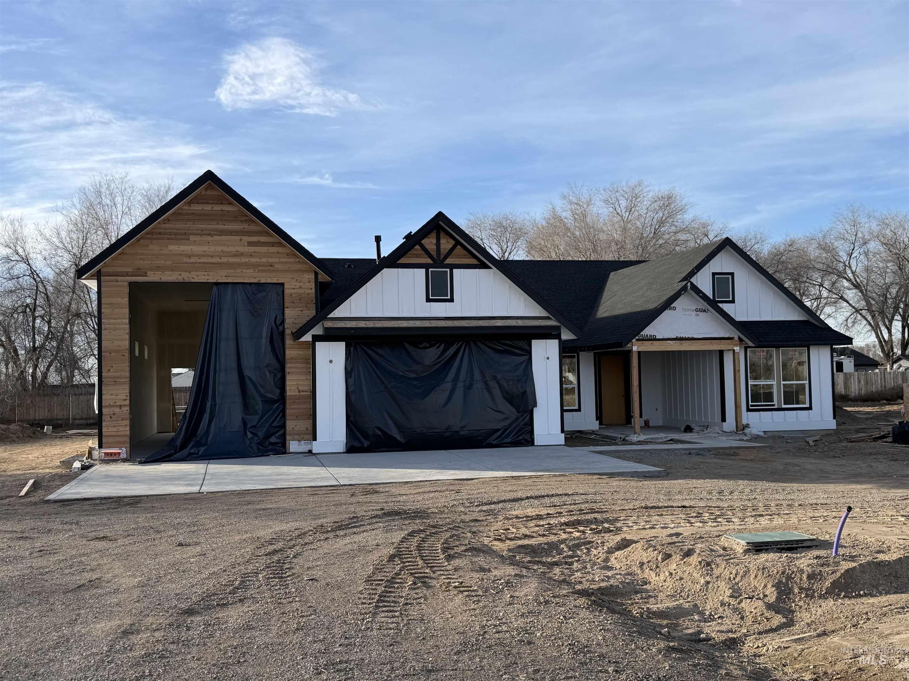 Modern farmhouse featuring driveway and covered porch