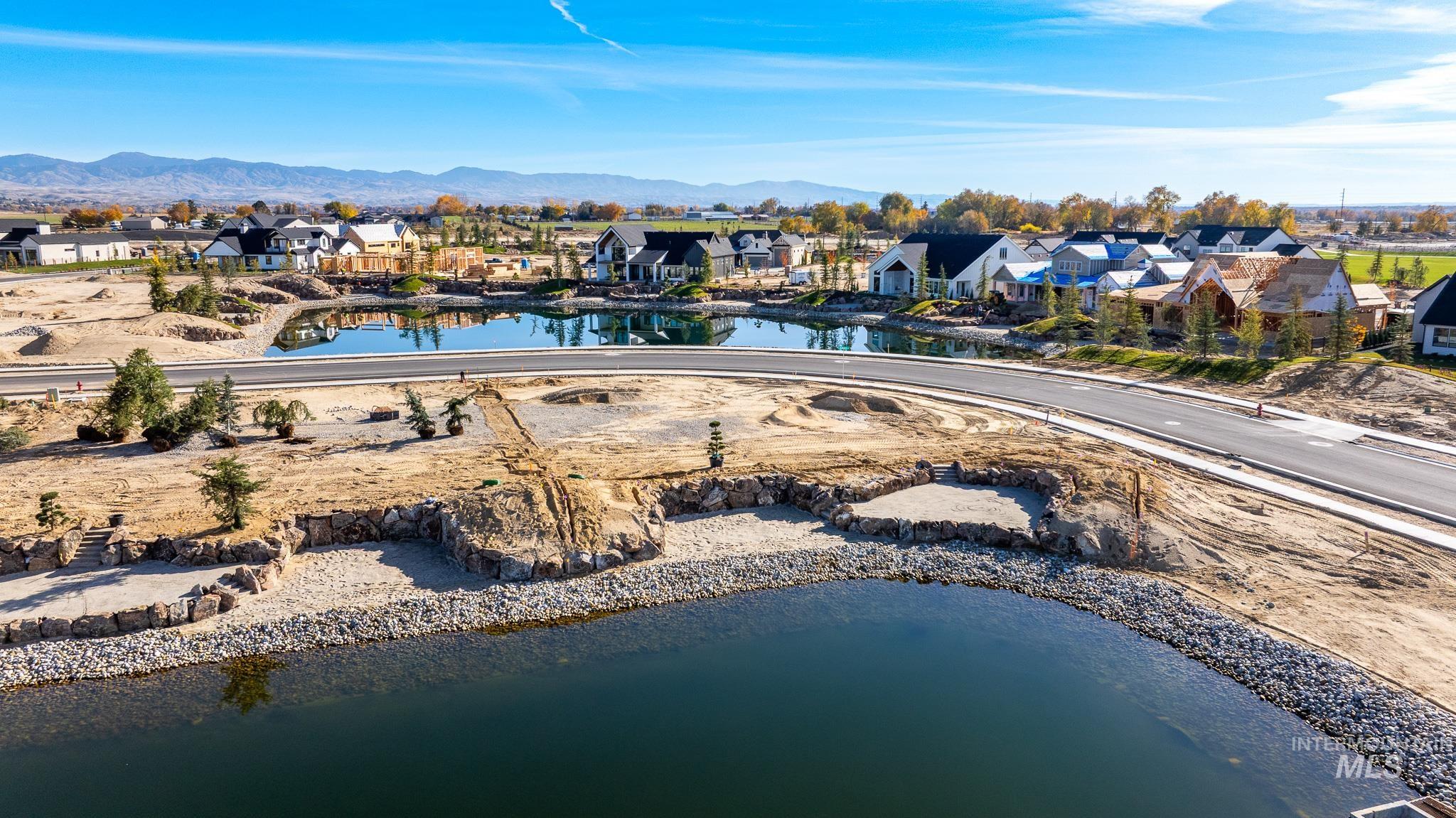 Aerial perspective of suburban area featuring a water and mountain view