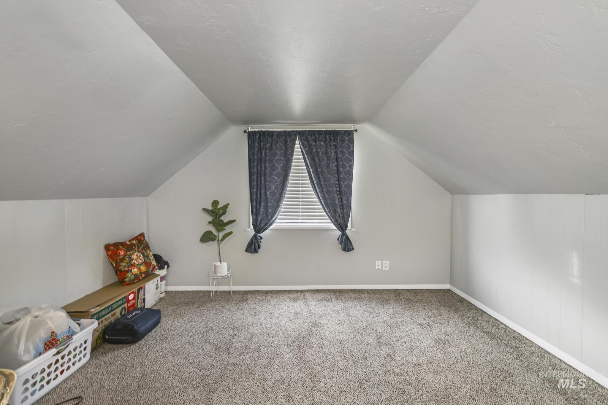 Bonus room featuring carpet flooring and lofted ceiling