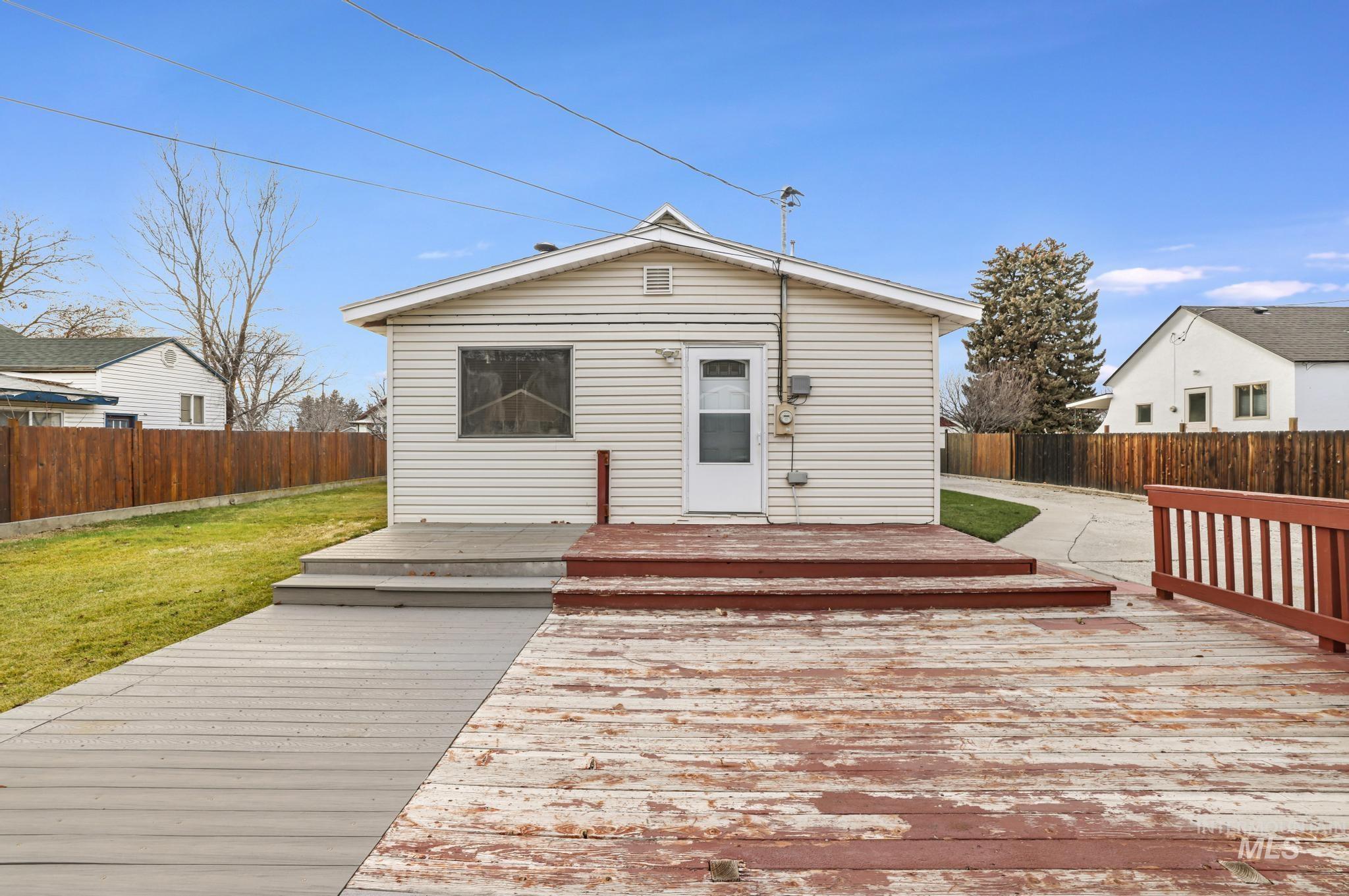 Rear view of property featuring a fenced backyard and a deck