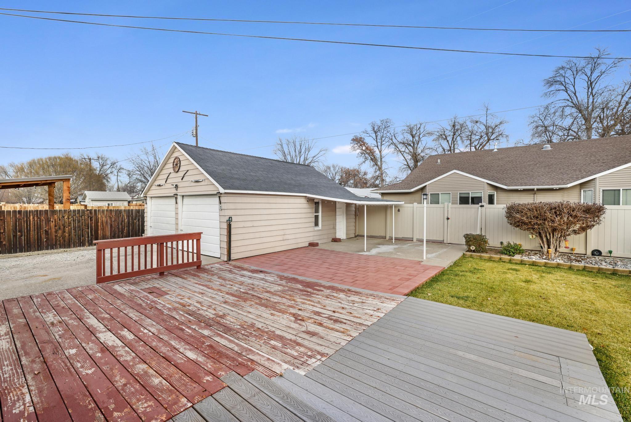 Wooden deck featuring a patio and a fenced backyard